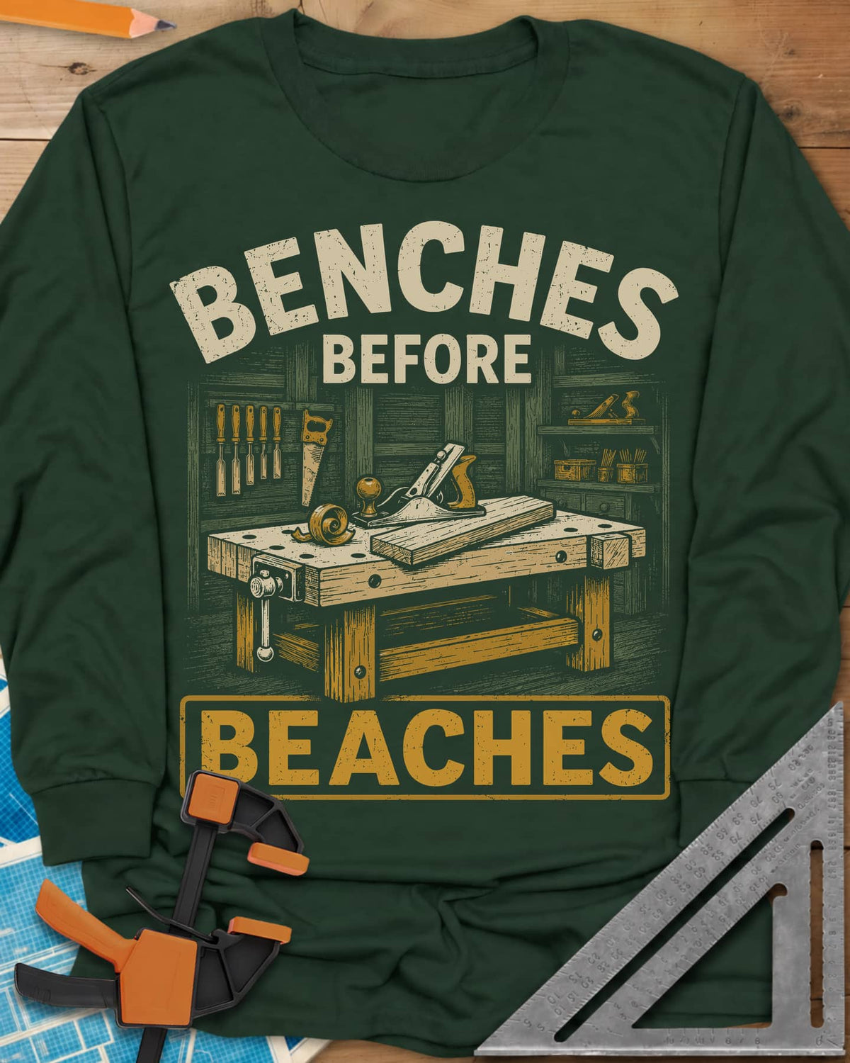 Benches Before Beaches long sleeve shirt in Forest Green, a woodworking bench with a hand plane, chisels and a saw on the