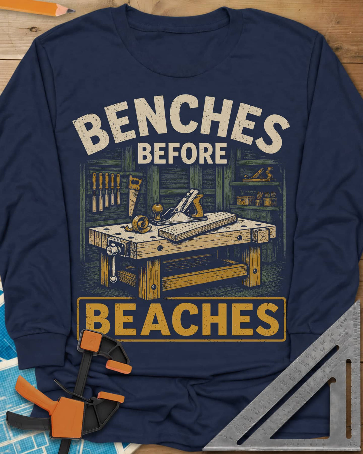 Benches Before Beaches long sleeve shirt in Navy, a woodworking bench with a hand plane, chisels and a saw on the wall