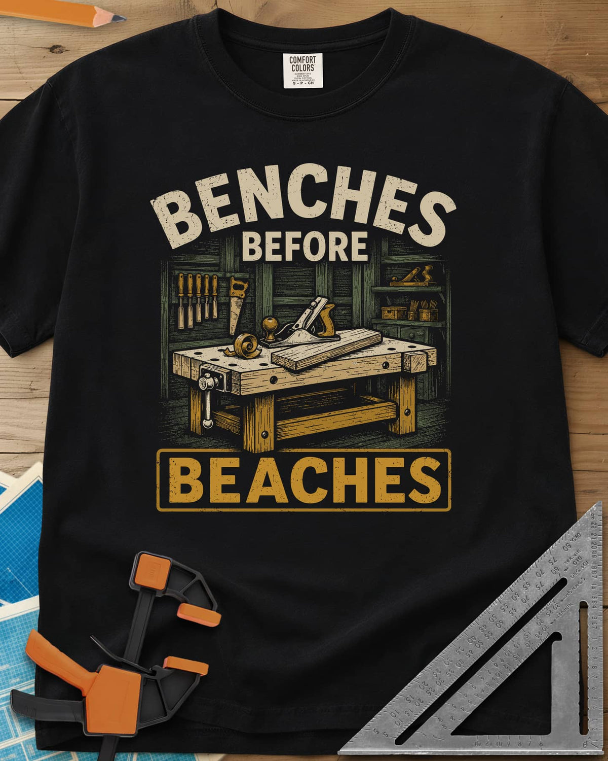 Benches Before Beaches heavyweight tee in Black, a woodworking bench with a hand plane, chisels and a saw on the wall