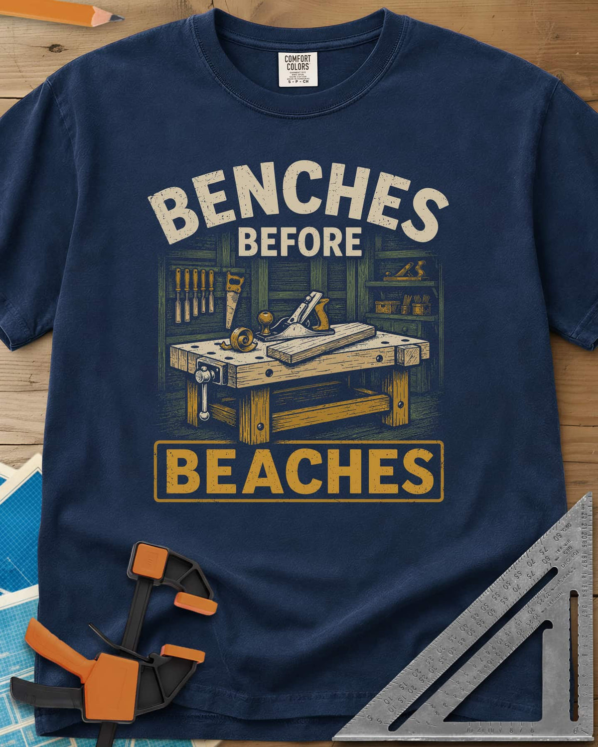 Benches Before Beaches heavyweight tee in Navy, a woodworking bench with a hand plane, chisels and a saw on the wall