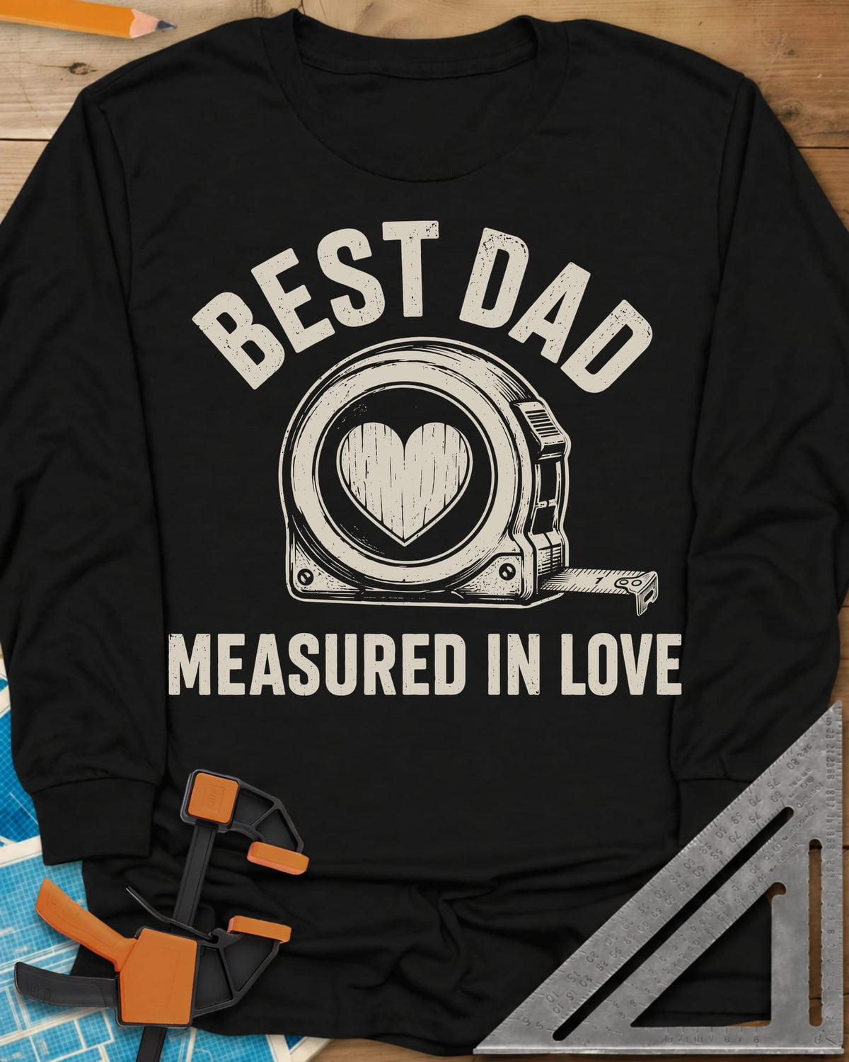 Best Dad Measured In Love long sleeve shirt in Black, a round tape measure with a wood-grain heart on its face