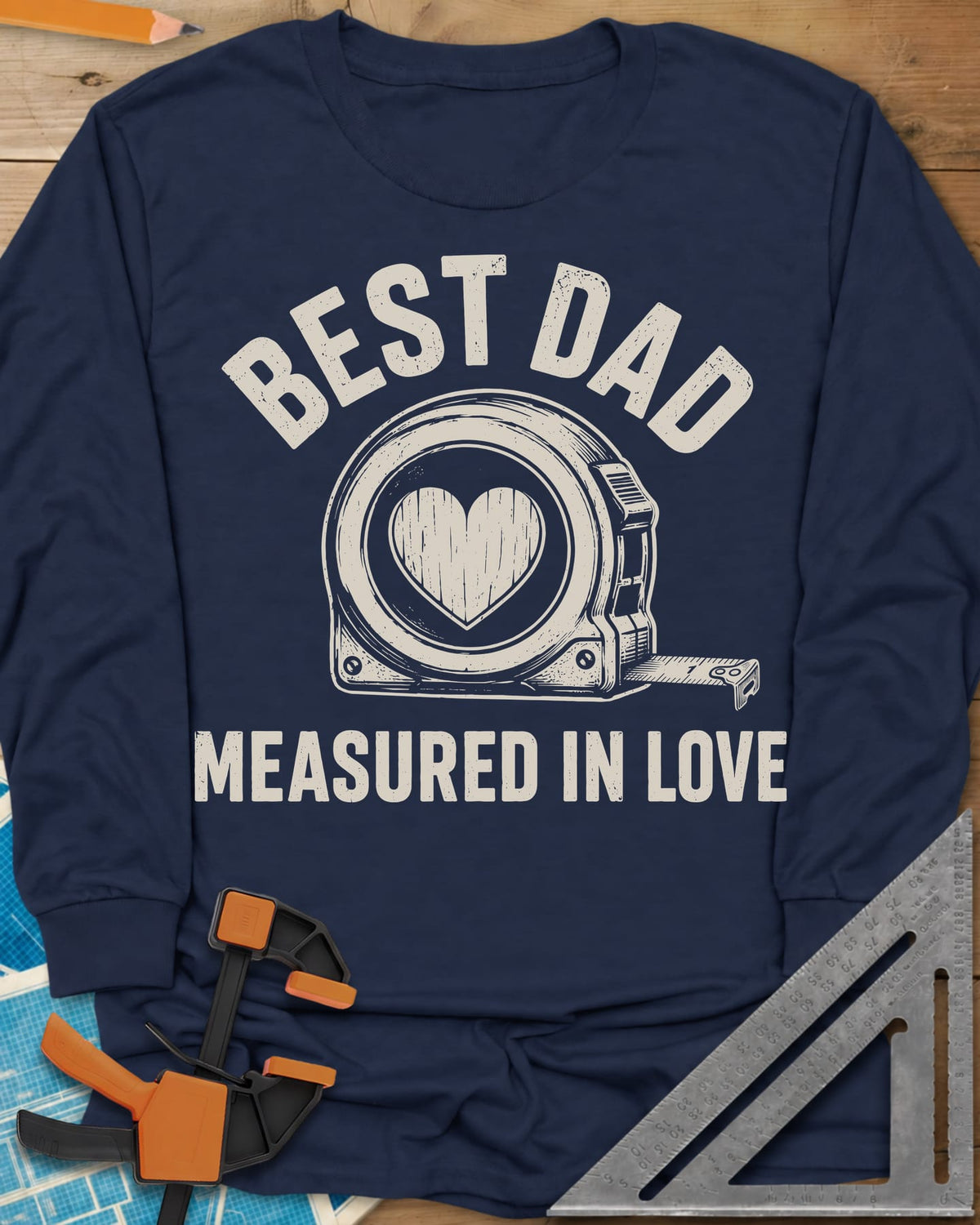 Best Dad Measured In Love long sleeve shirt in Navy, a round tape measure with a wood-grain heart on its face