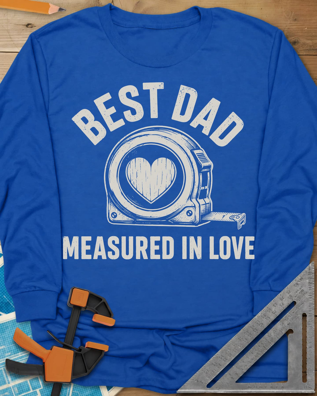 Best Dad Measured In Love long sleeve shirt in Royal, a round tape measure with a wood-grain heart on its face