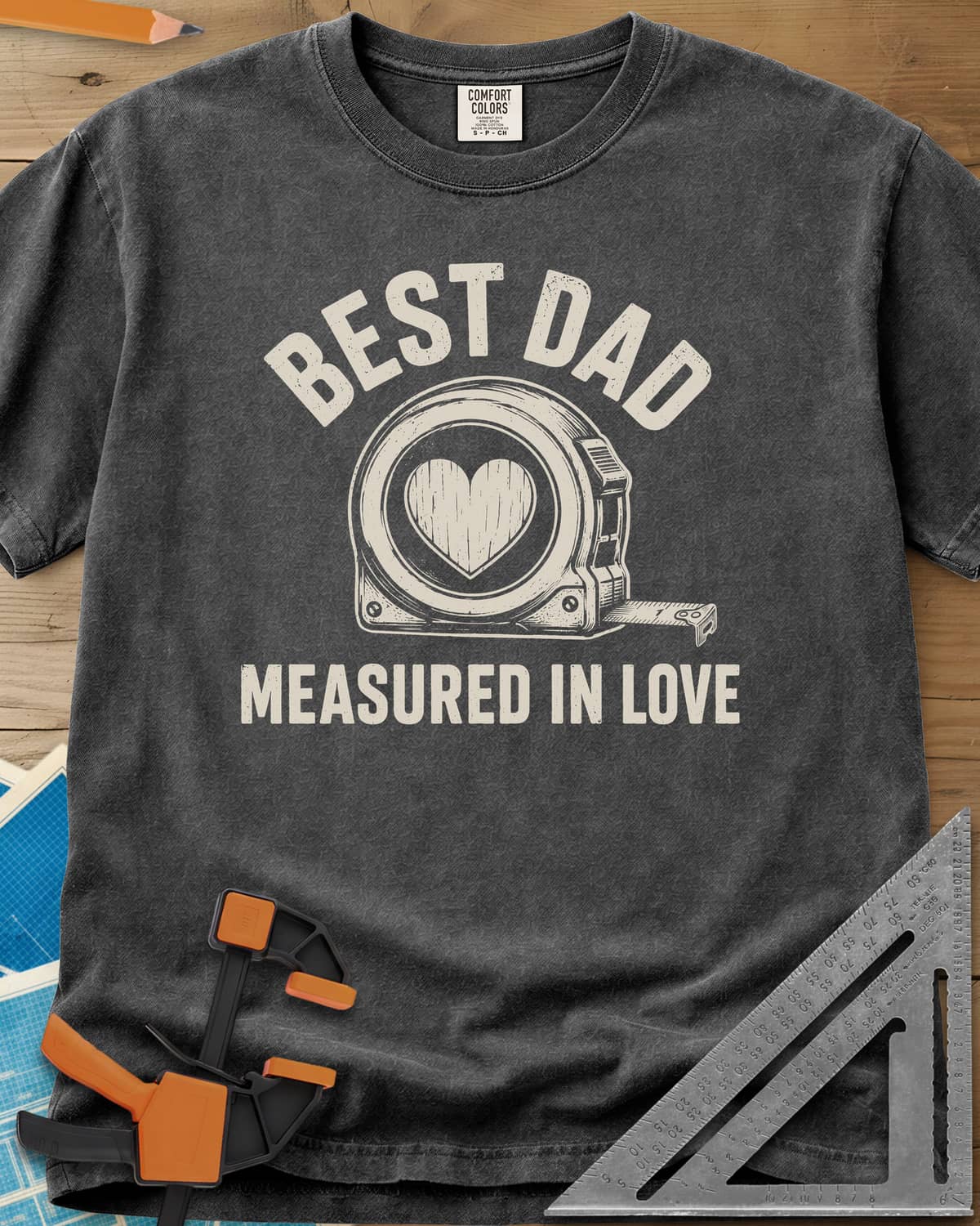 Best Dad Measured In Love heavyweight tee in Pepper, a round tape measure with a wood-grain heart on its face