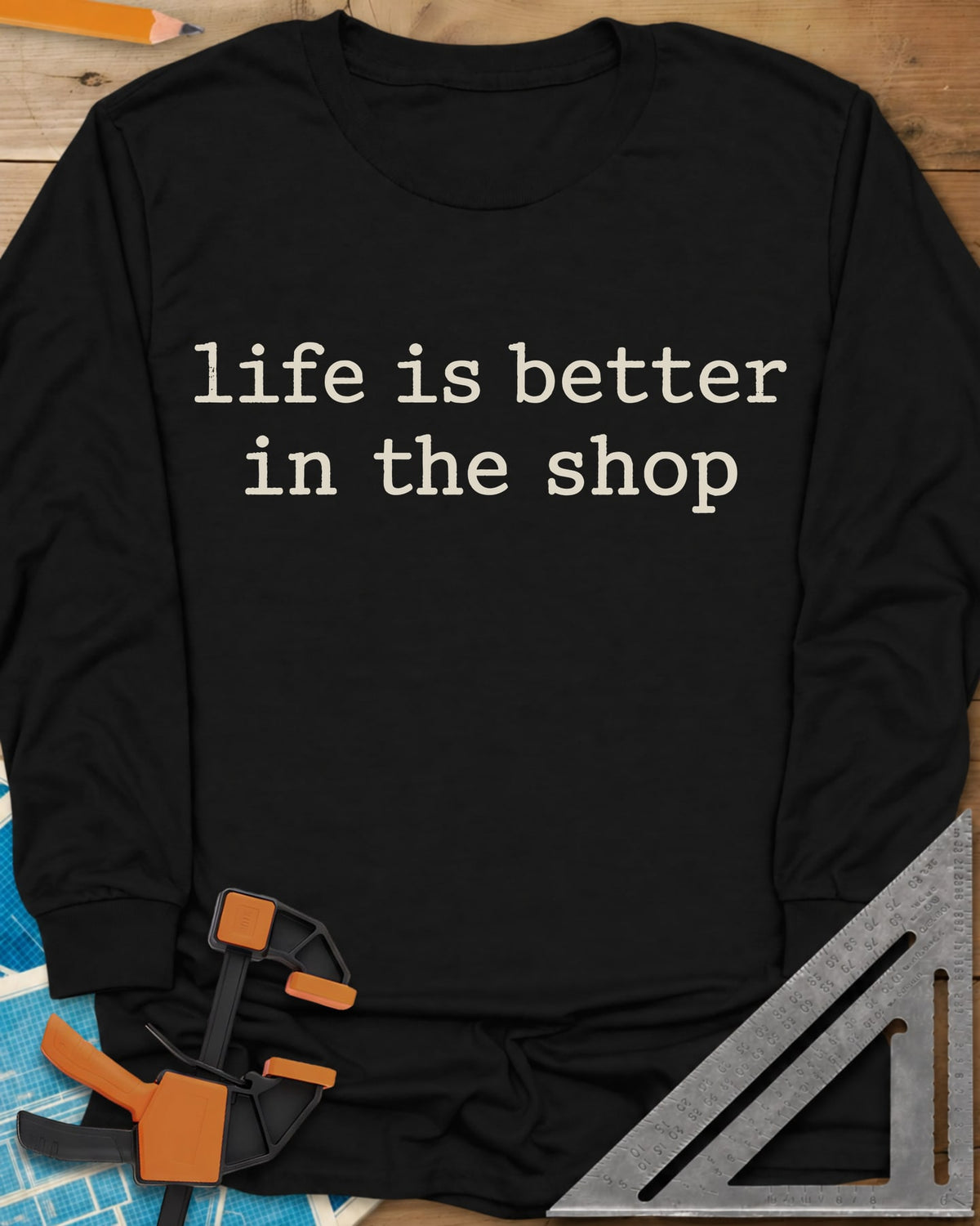 Better In The Shop long sleeve shirt in Black, plain typewriter-style lowercase text on two lines, no graphic