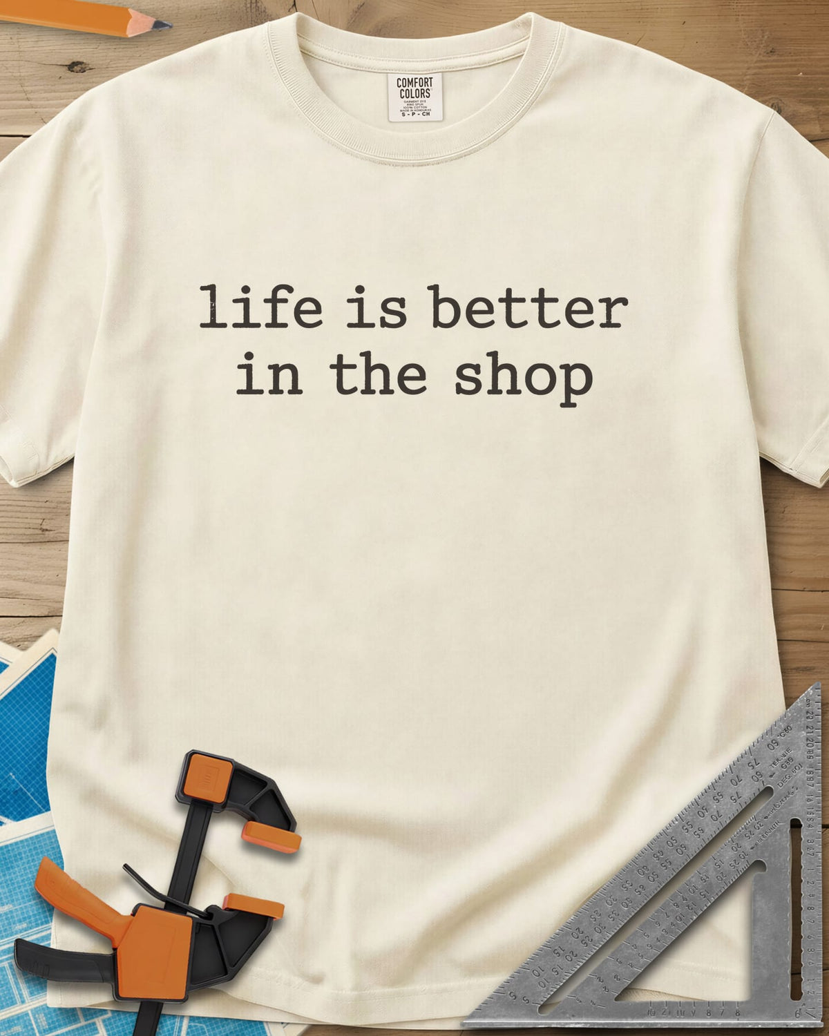 Better In The Shop heavyweight tee in Ivory, plain typewriter-style lowercase text on two lines, no graphic