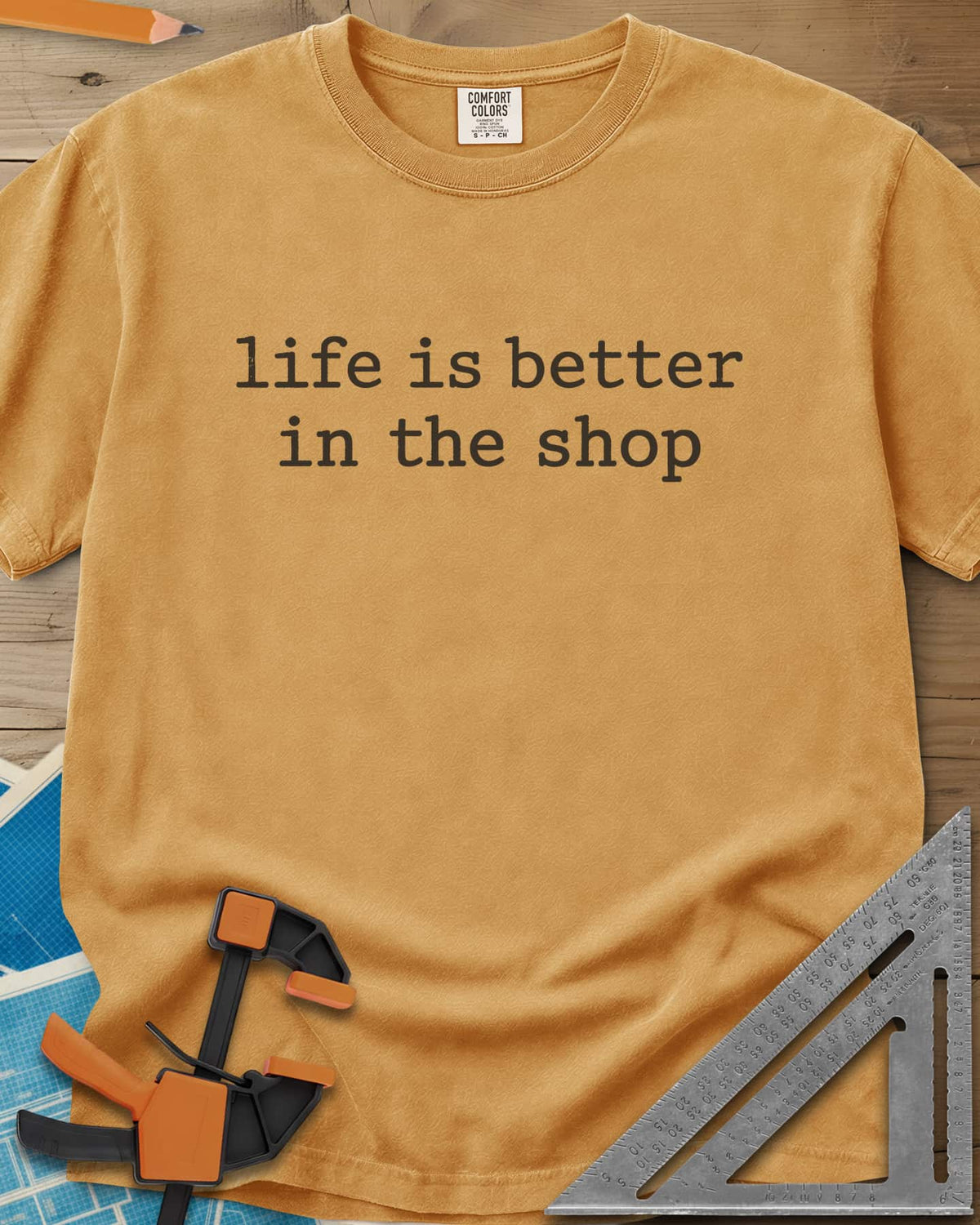 Better In The Shop heavyweight tee in Mustard, plain typewriter-style lowercase text on two lines, no graphic