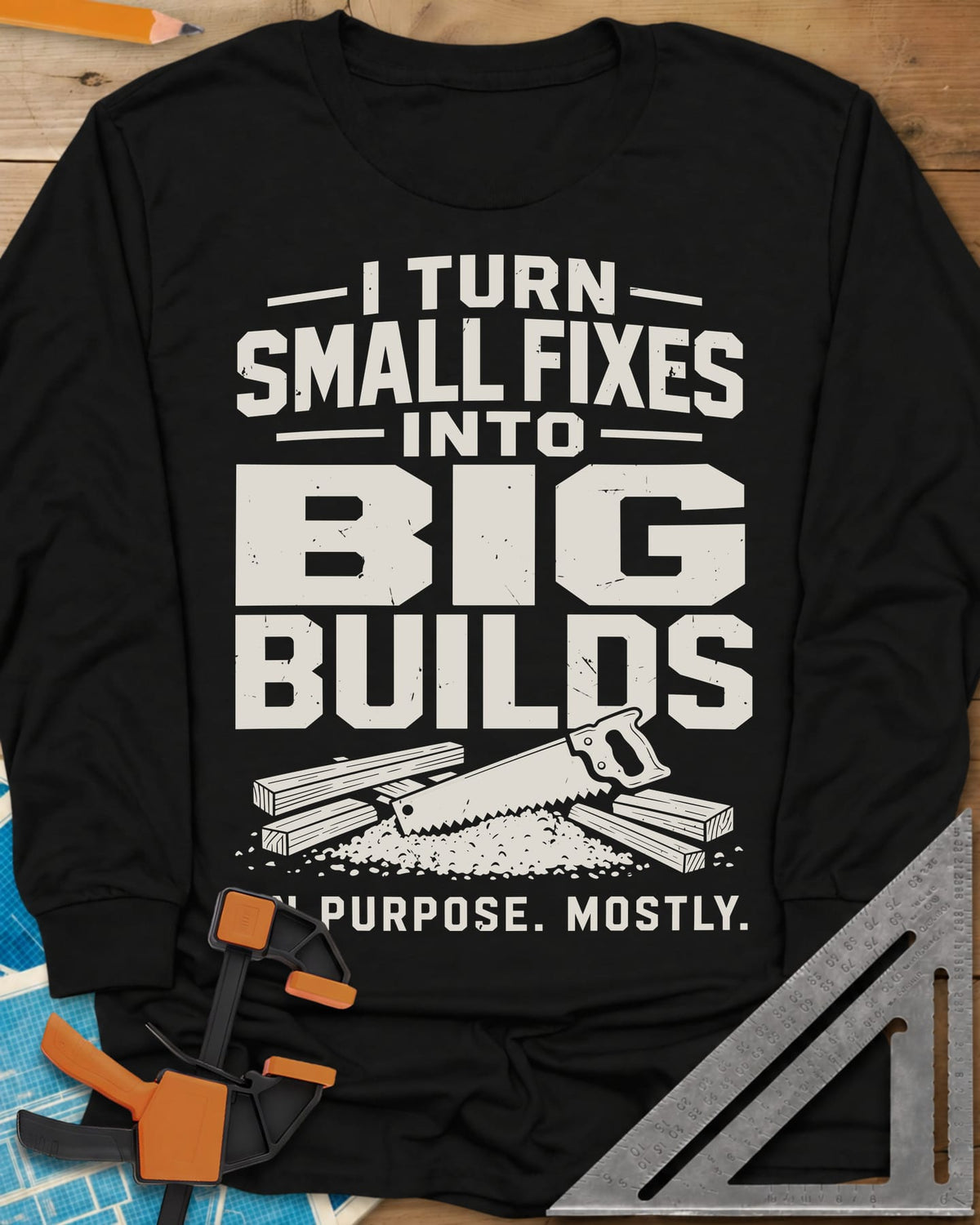 Big Builds long sleeve shirt in Black, a handsaw resting on cut boards and a heap of sawdust