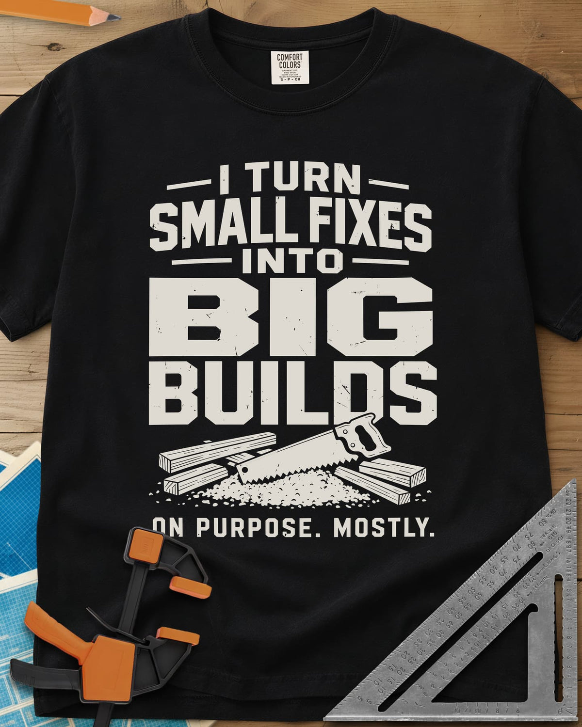 Big Builds heavyweight tee in Black, a handsaw resting on cut boards and a heap of sawdust
