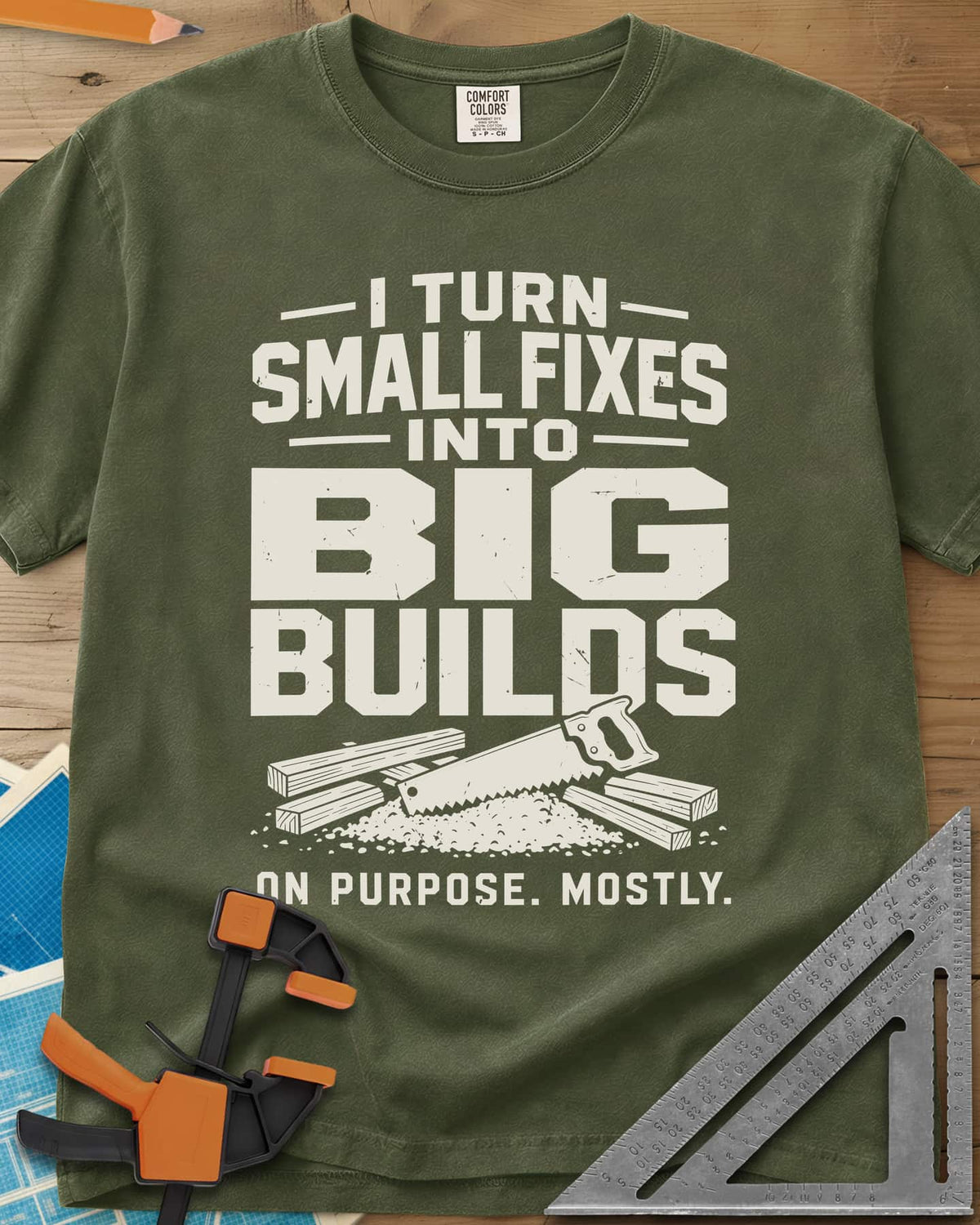 Big Builds heavyweight tee in Hemp, a handsaw resting on cut boards and a heap of sawdust