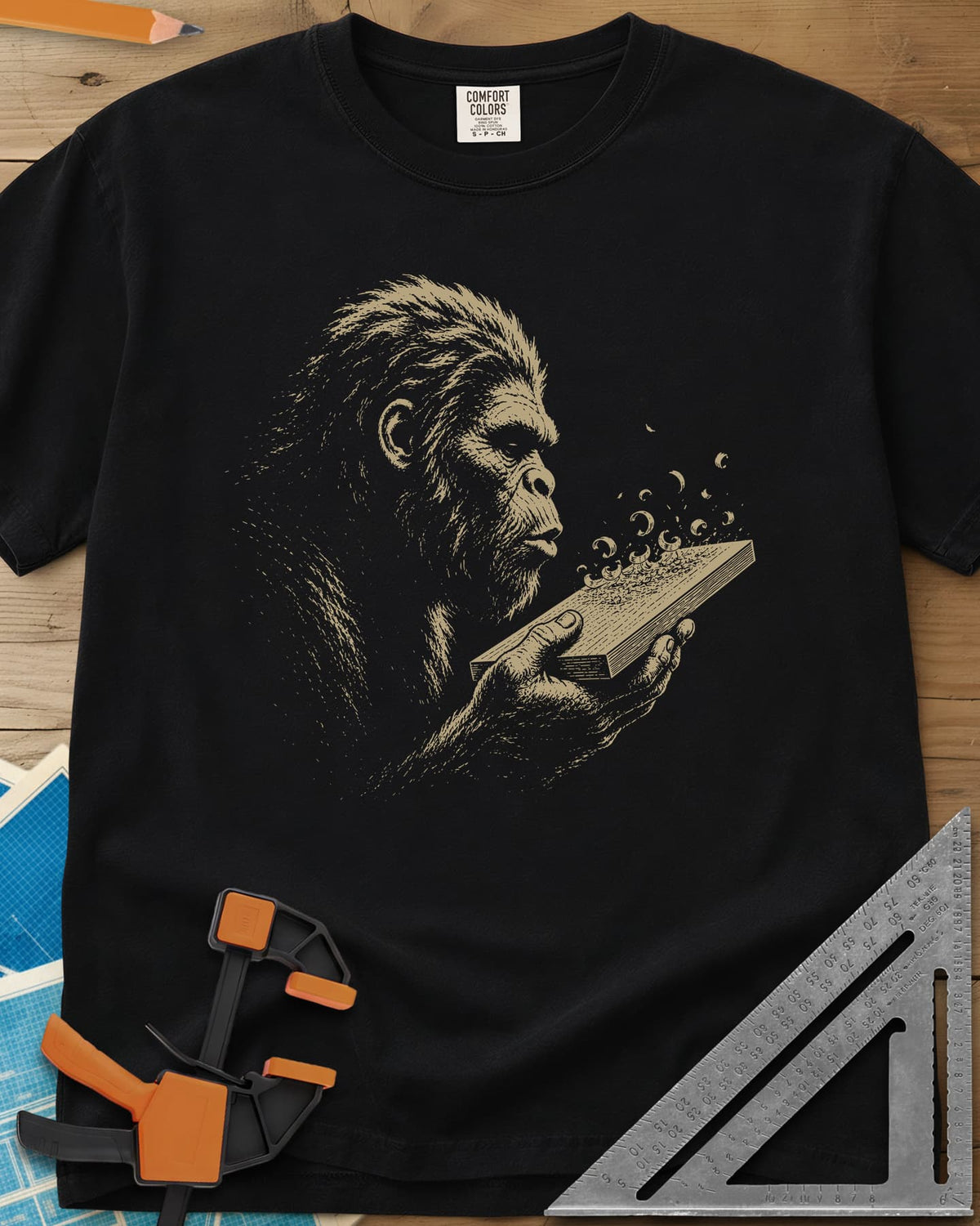 Bigfoot Blowing Sawdust heavyweight tee in Black, Bigfoot in fine line work blowing sawdust curls off a board