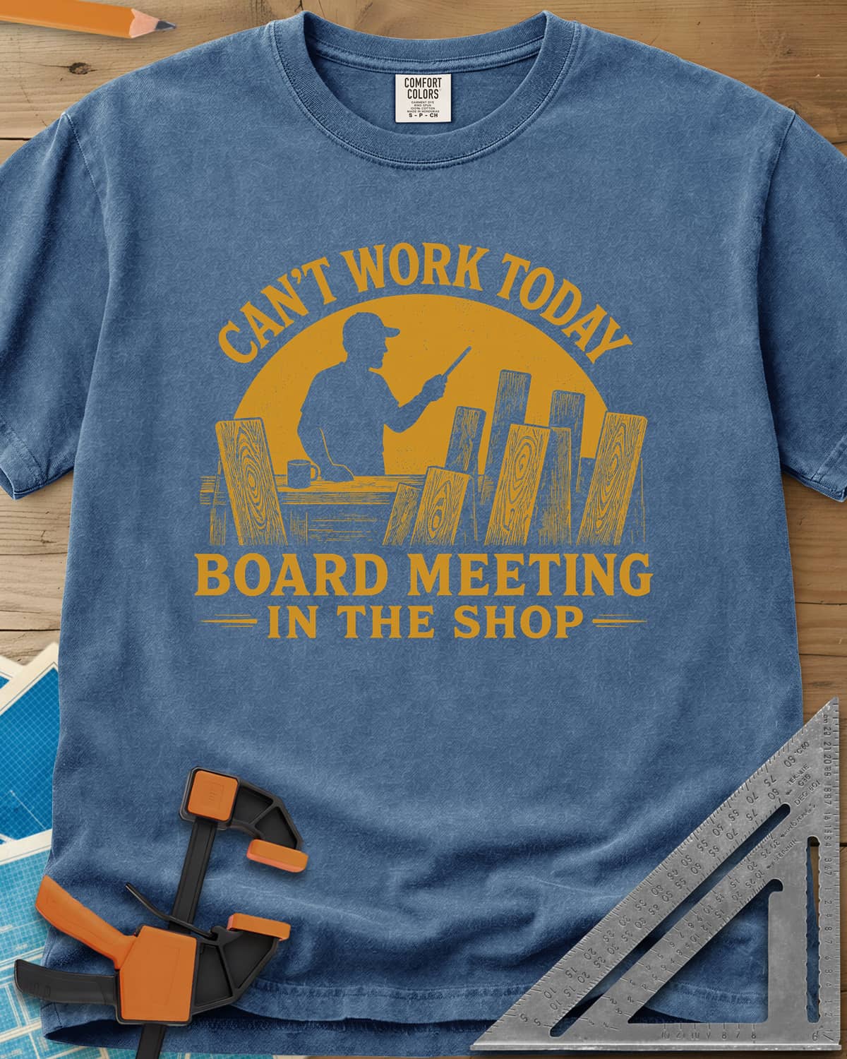 Board Meeting heavyweight tee in Blue Jean, a man presenting to a row of upright boards under a big sun