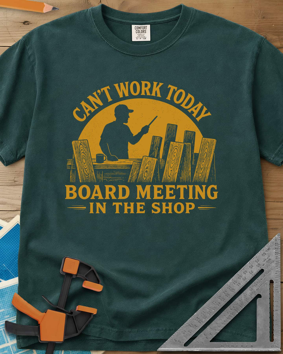 Board Meeting heavyweight tee in Blue Spruce, a man presenting to a row of upright boards under a big sun