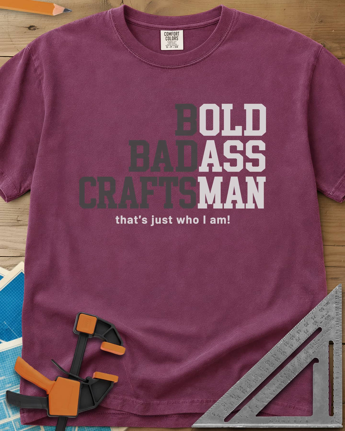 Bold Badass Craftsman heavyweight tee in Berry, stacked block letters split into grey and white halves