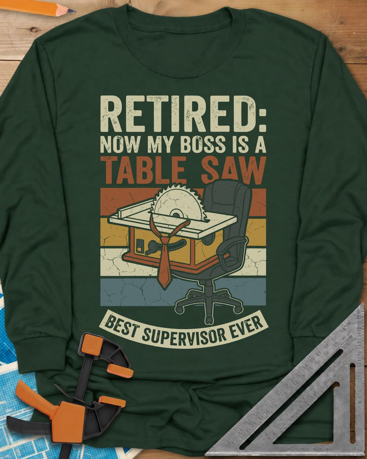 Boss Is a Table Saw long sleeve shirt in Forest Green, a table saw in a necktie beside an empty office chair