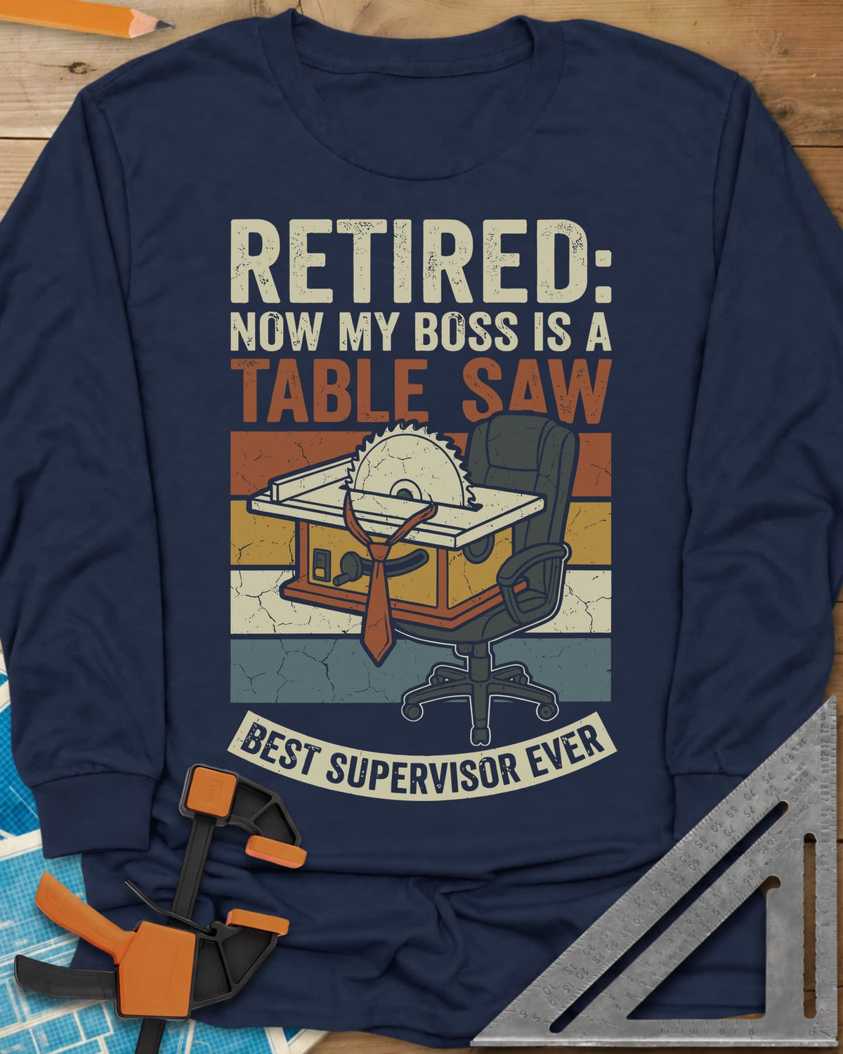Boss Is a Table Saw long sleeve shirt in Navy, a table saw in a necktie beside an empty office chair