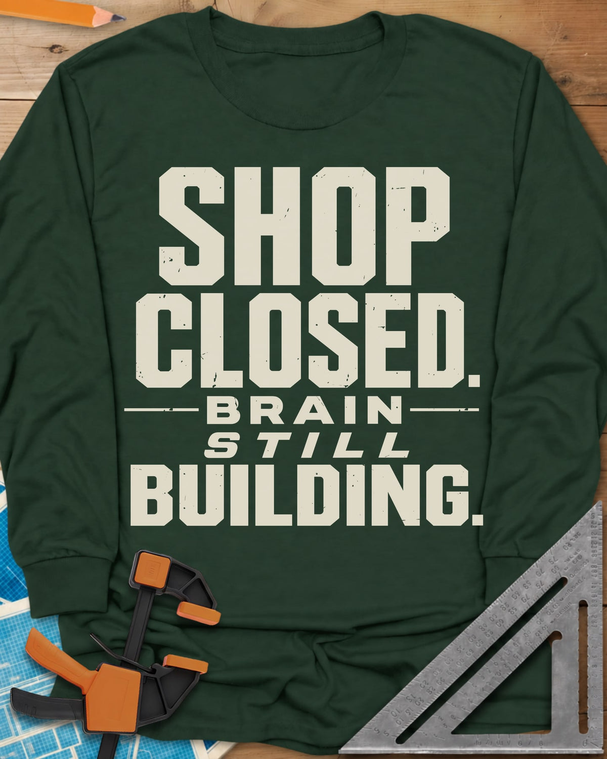 Brain Building long sleeve shirt in Forest Green, stacked block lettering with STILL in italics, no graphic