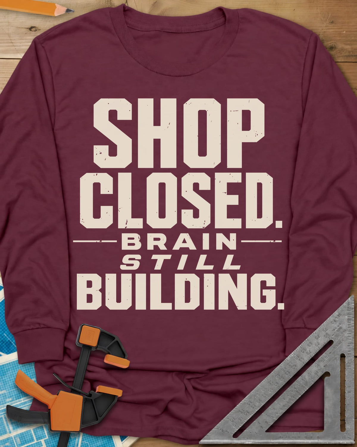 Brain Building long sleeve shirt in Maroon, stacked block lettering with STILL in italics, no graphic