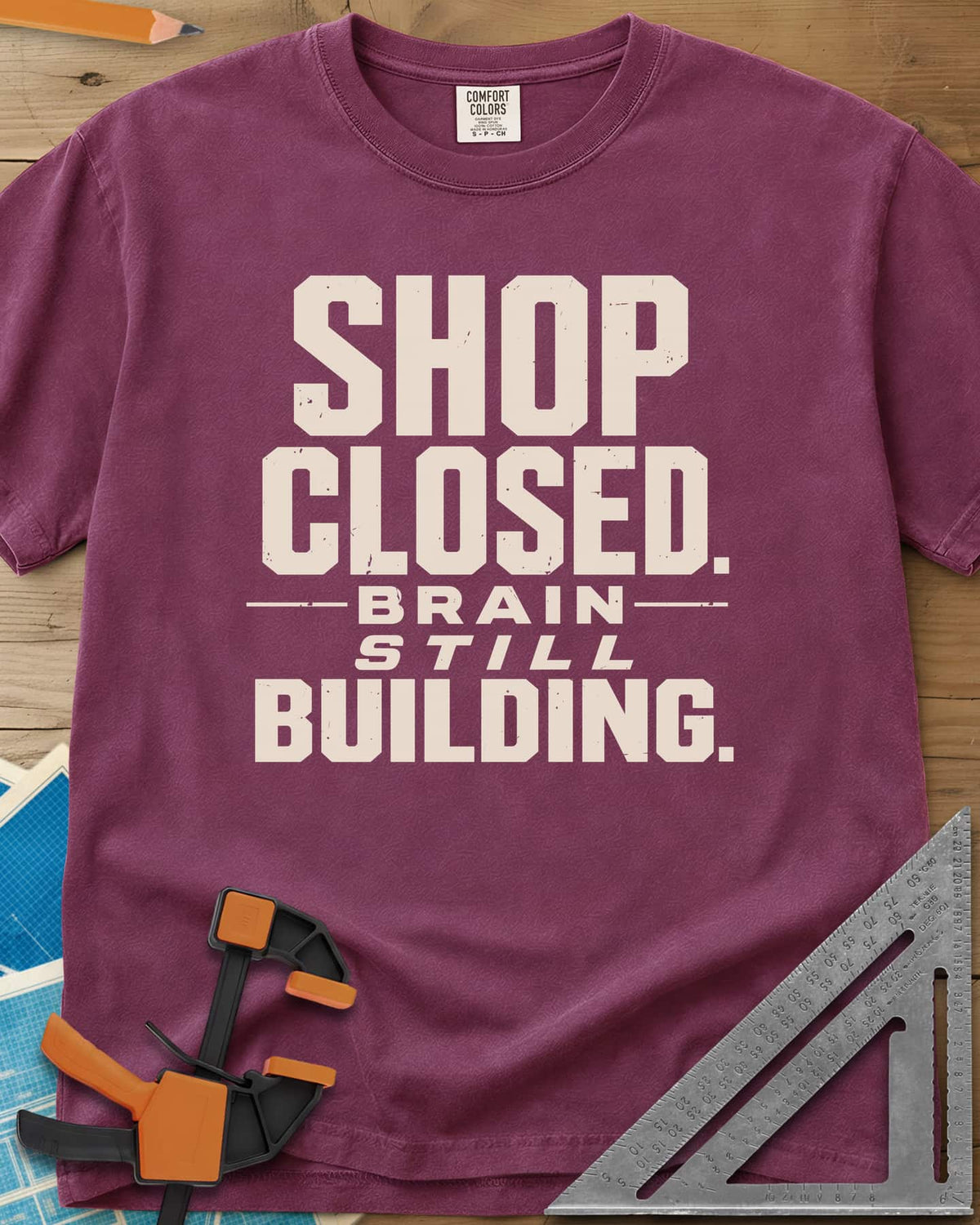 Brain Building heavyweight tee in Berry, stacked block lettering with STILL in italics, no graphic
