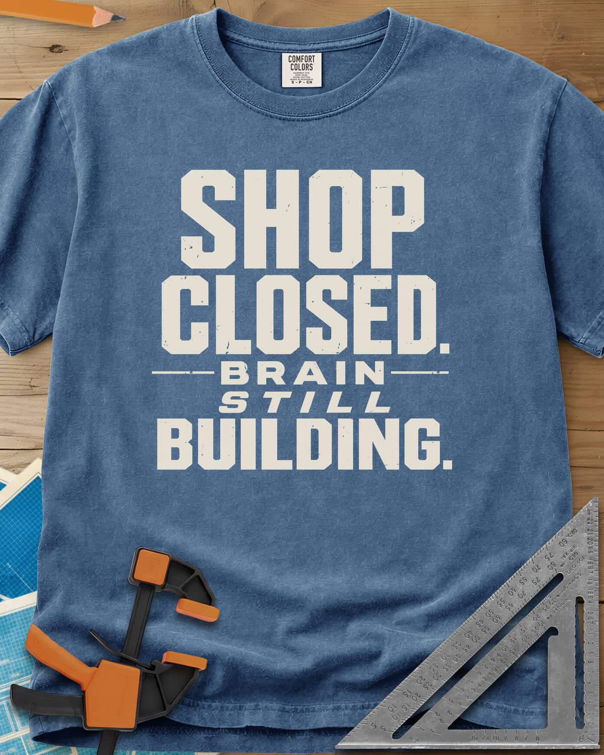 Brain Building heavyweight tee in Blue Jean, stacked block lettering with STILL in italics, no graphic