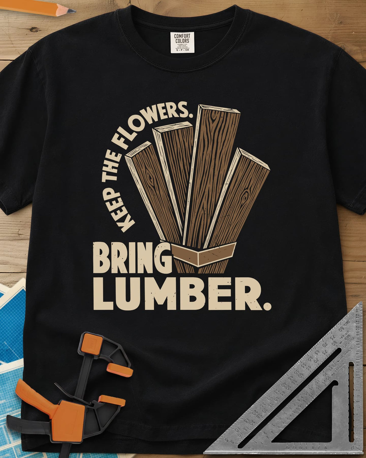 Bring Lumber heavyweight tee in Black, four wood-grain boards fanned out like a bouquet