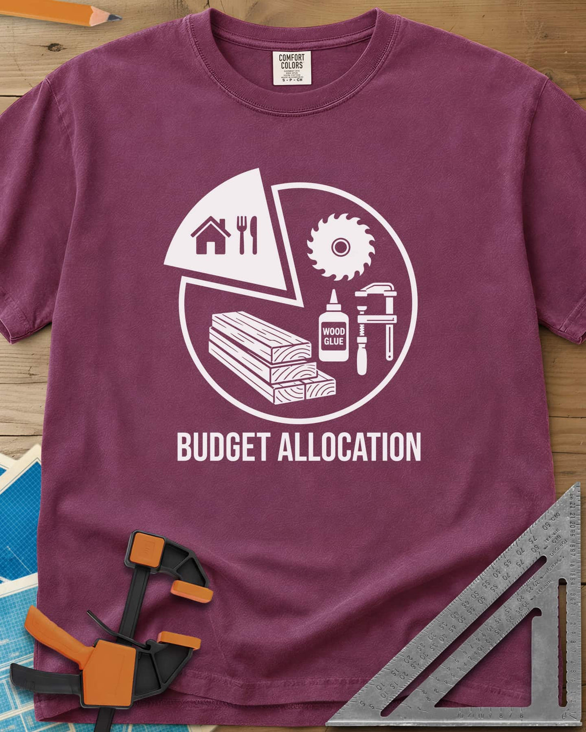 Budget Allocation heavyweight tee in Berry, pie chart: a small house and meal slice, the rest woodworking gear