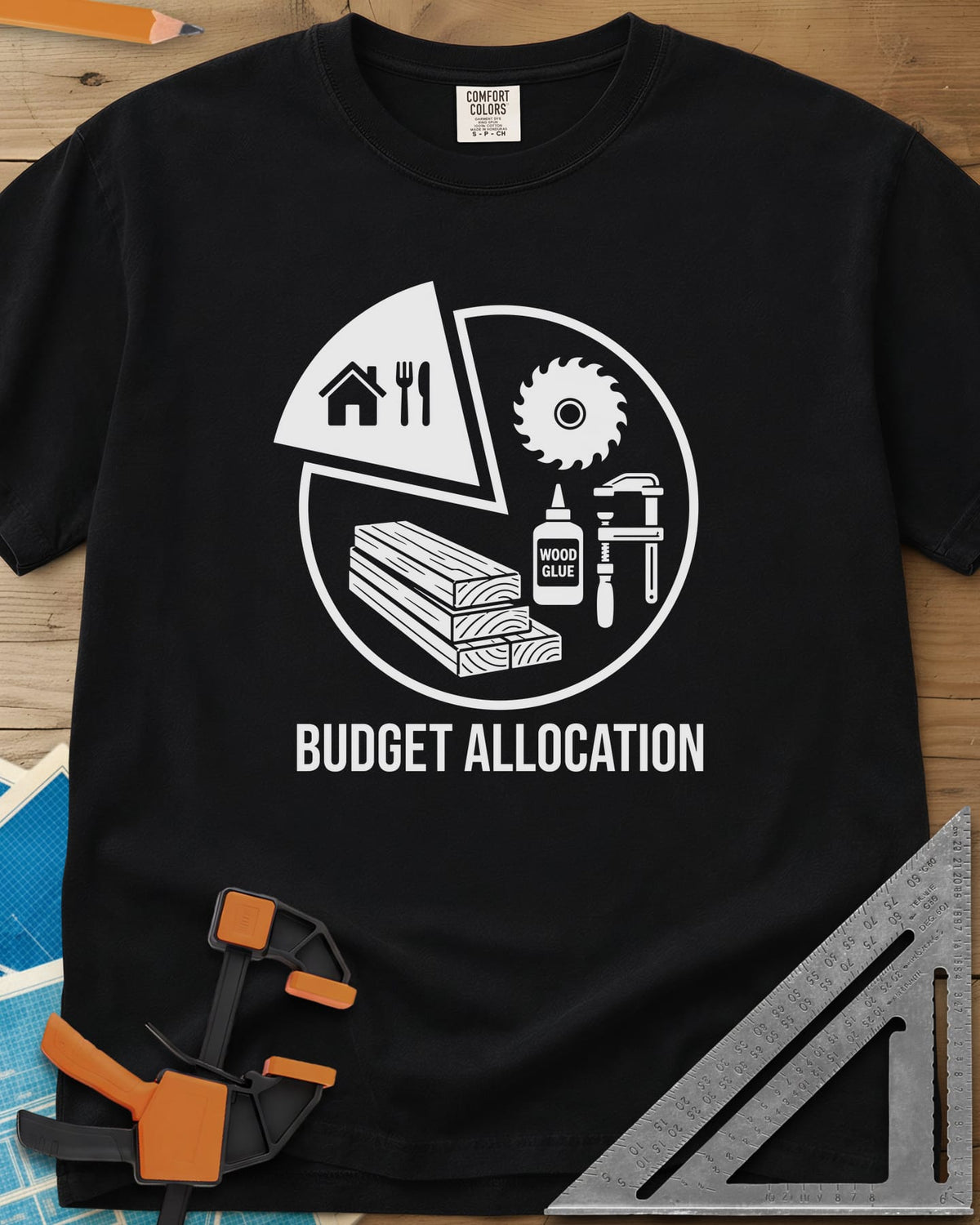 Budget Allocation heavyweight tee in Black, pie chart: a small house and meal slice, the rest woodworking gear