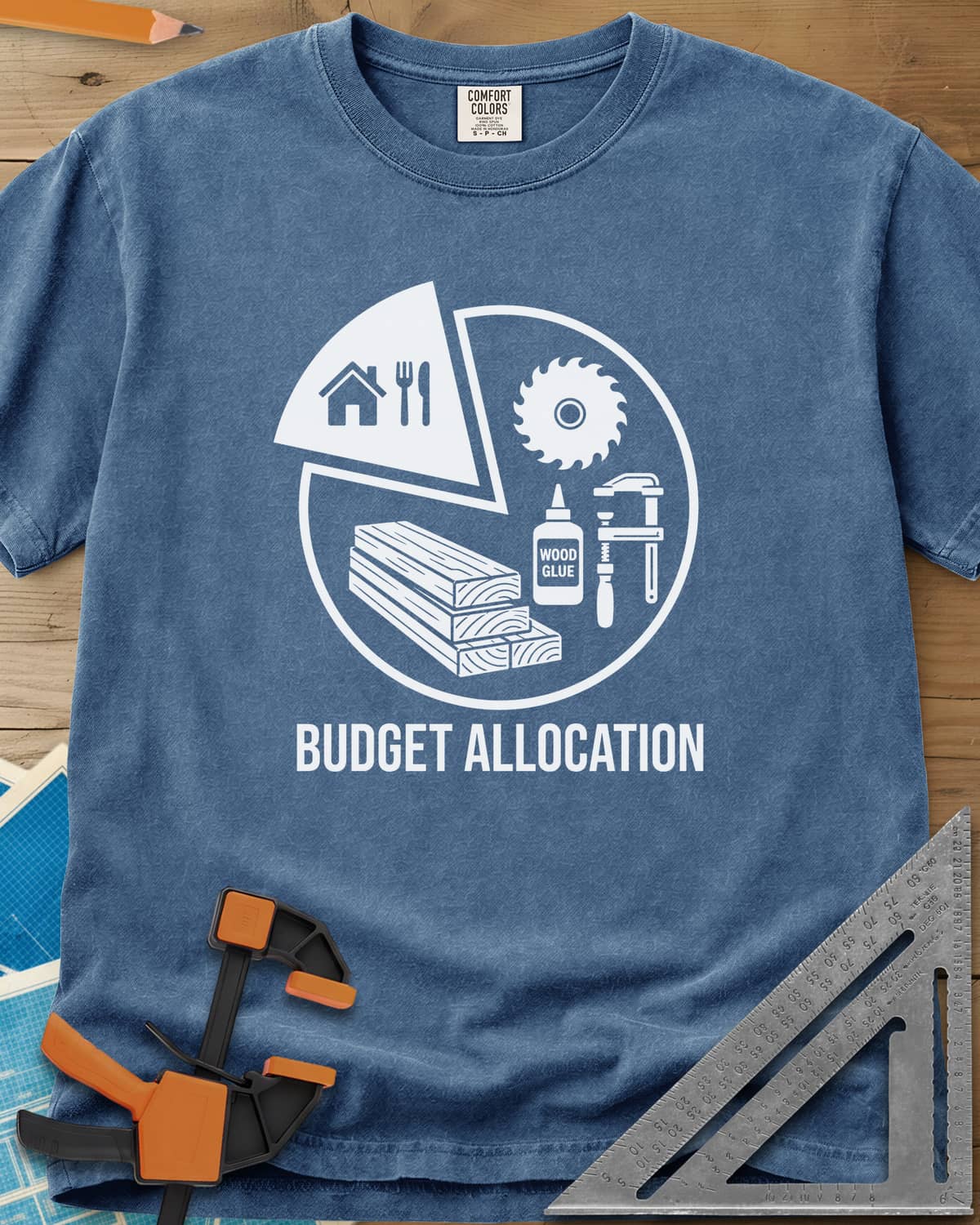 Budget Allocation heavyweight tee in Blue Jean, pie chart: a small house and meal slice, the rest woodworking gear