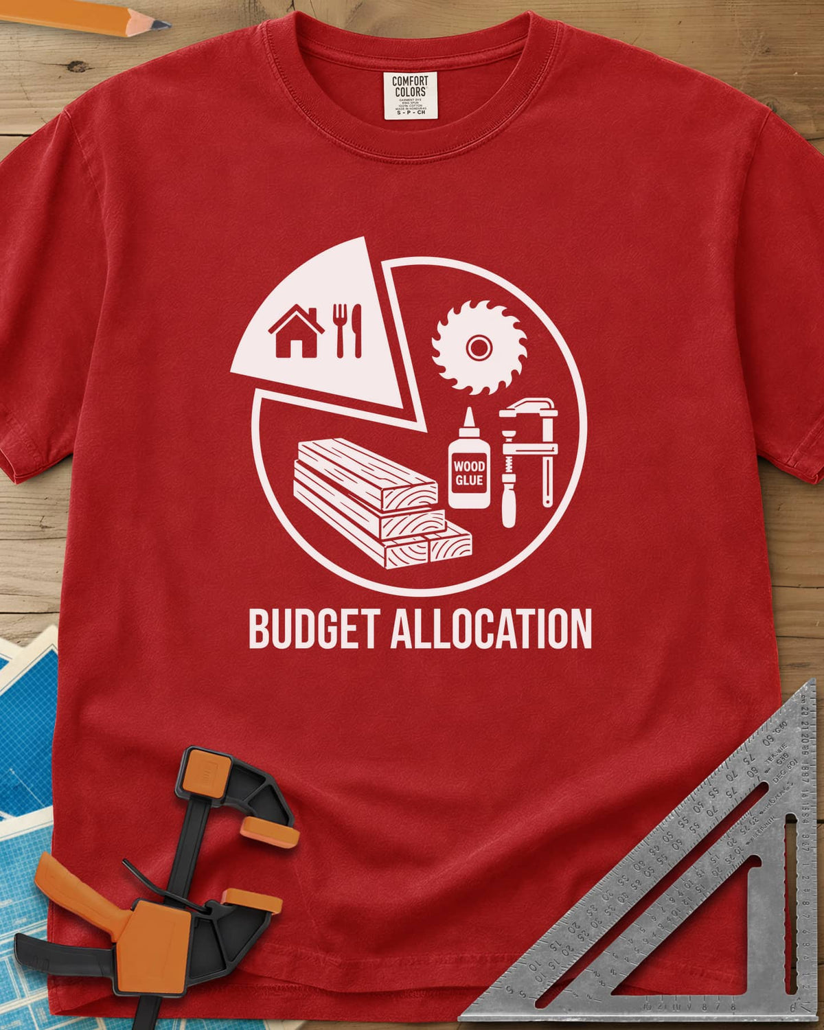 Budget Allocation heavyweight tee in Red, pie chart: a small house and meal slice, the rest woodworking gear