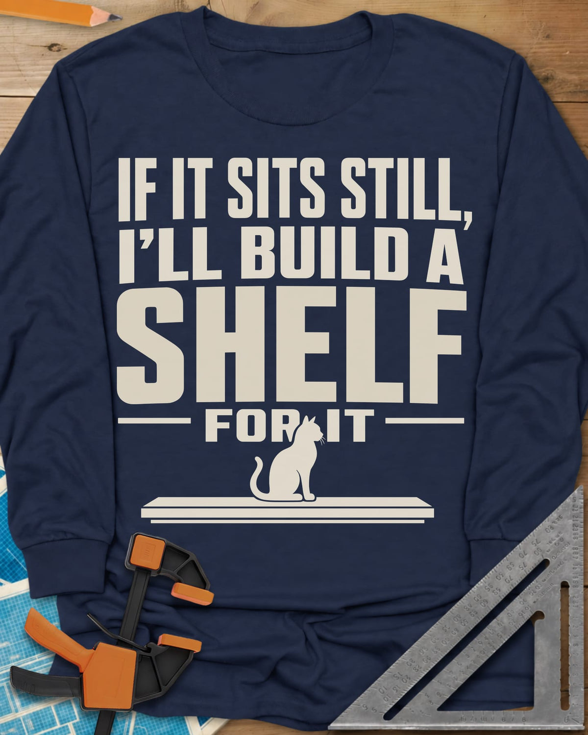 Build A Shelf long sleeve shirt in Navy, a cat sitting on a plain shelf board under the words