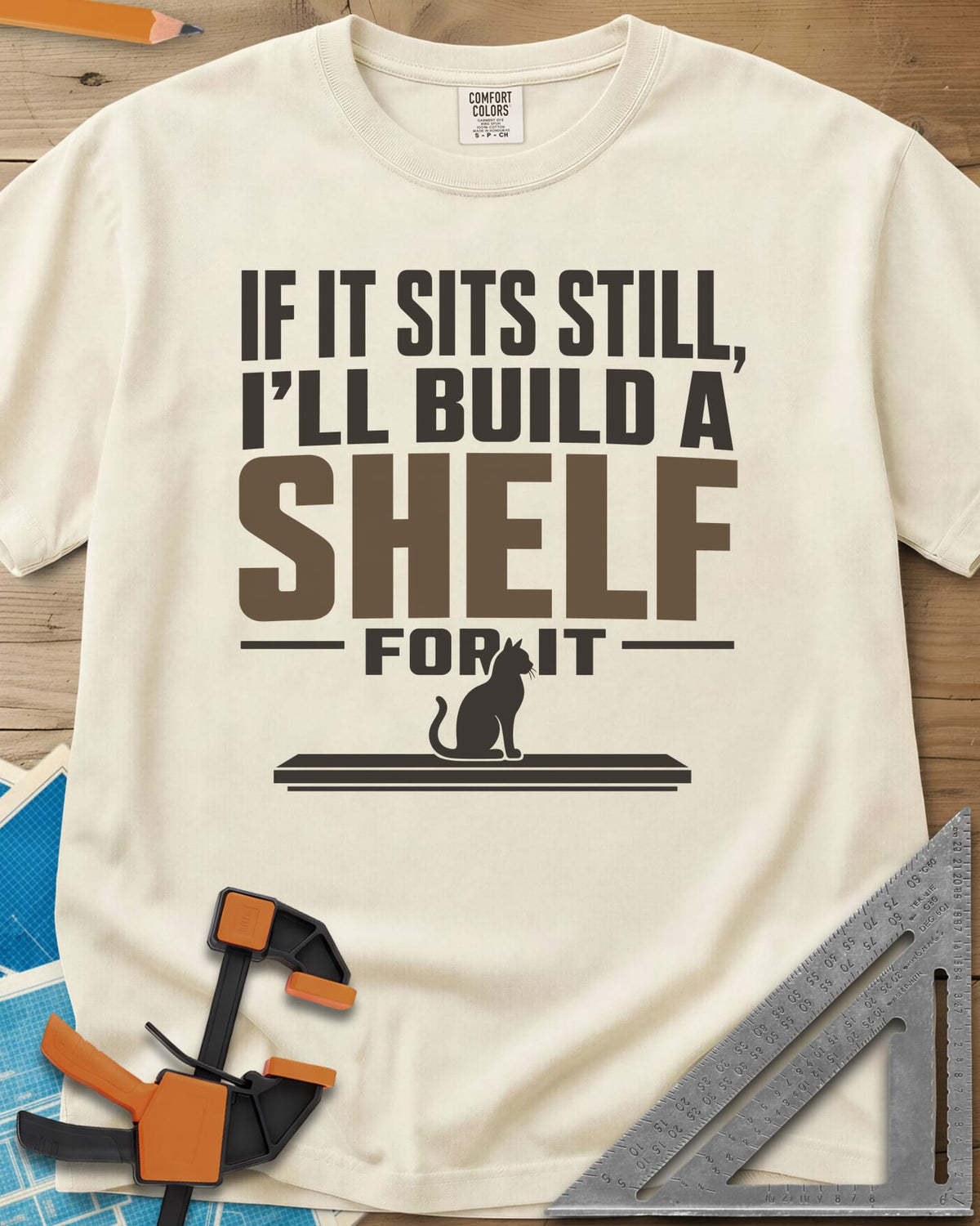 Build A Shelf heavyweight tee in Ivory, a cat sitting on a plain shelf board under the words