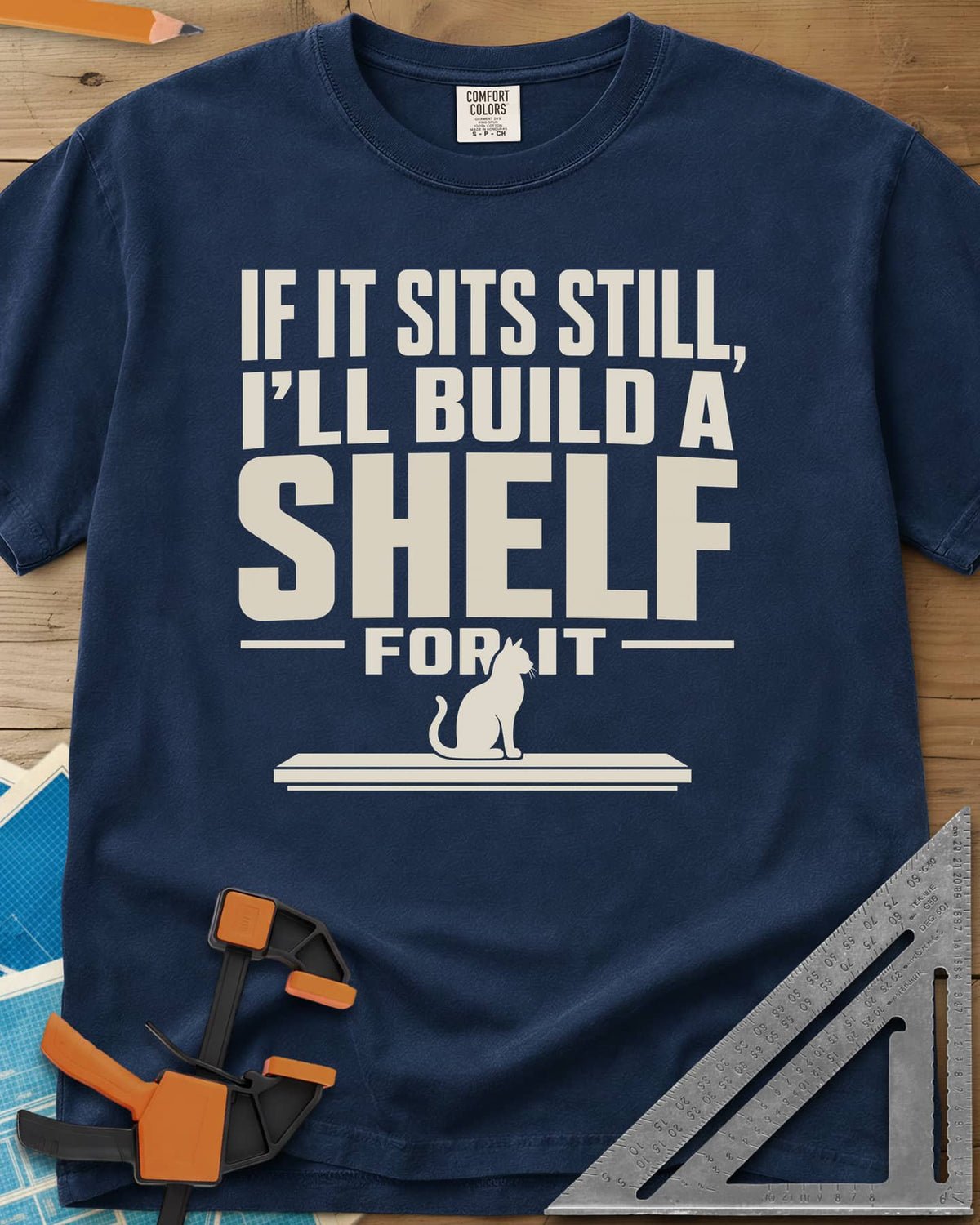 Build A Shelf heavyweight tee in Navy, a cat sitting on a plain shelf board under the words