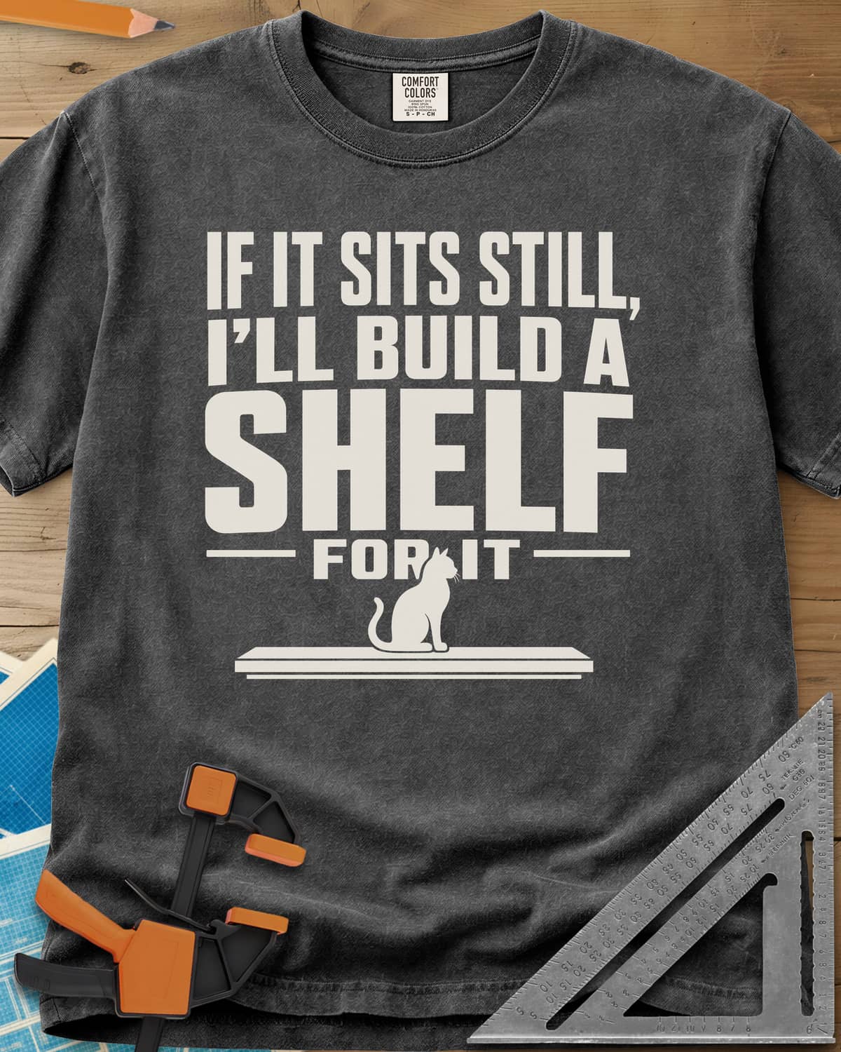 Build A Shelf heavyweight tee in Pepper, a cat sitting on a plain shelf board under the words