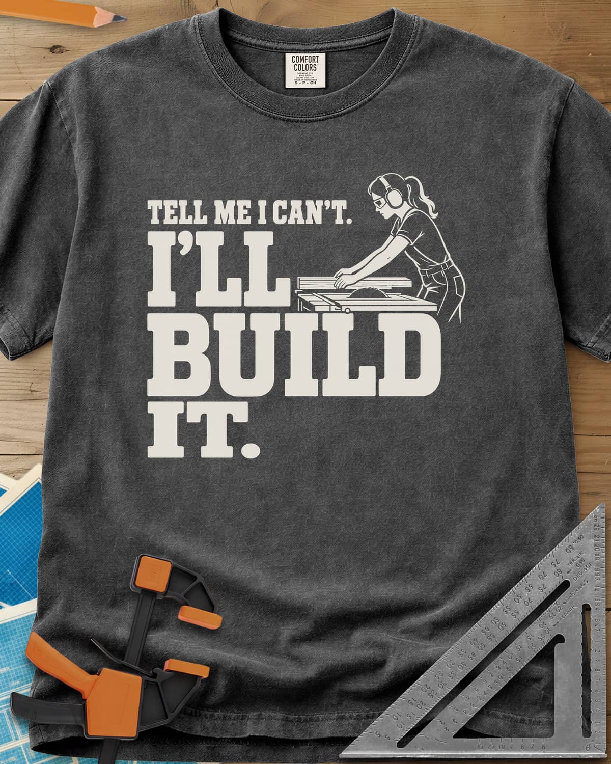Build It heavyweight tee in Pepper, a woman in ear protection and safety glasses at a table saw