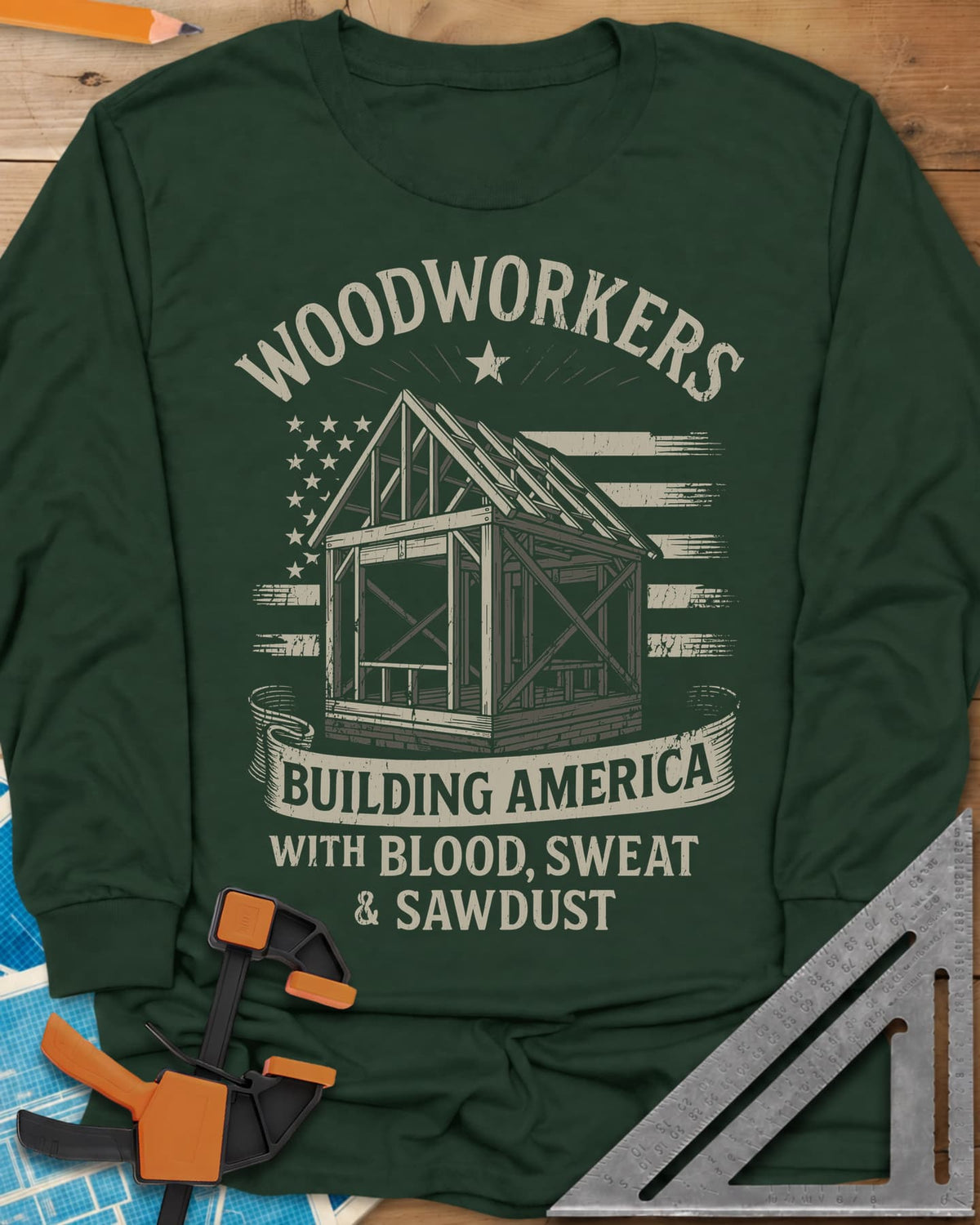 Building America long sleeve shirt in Forest Green, a timber frame in front of a worn American flag