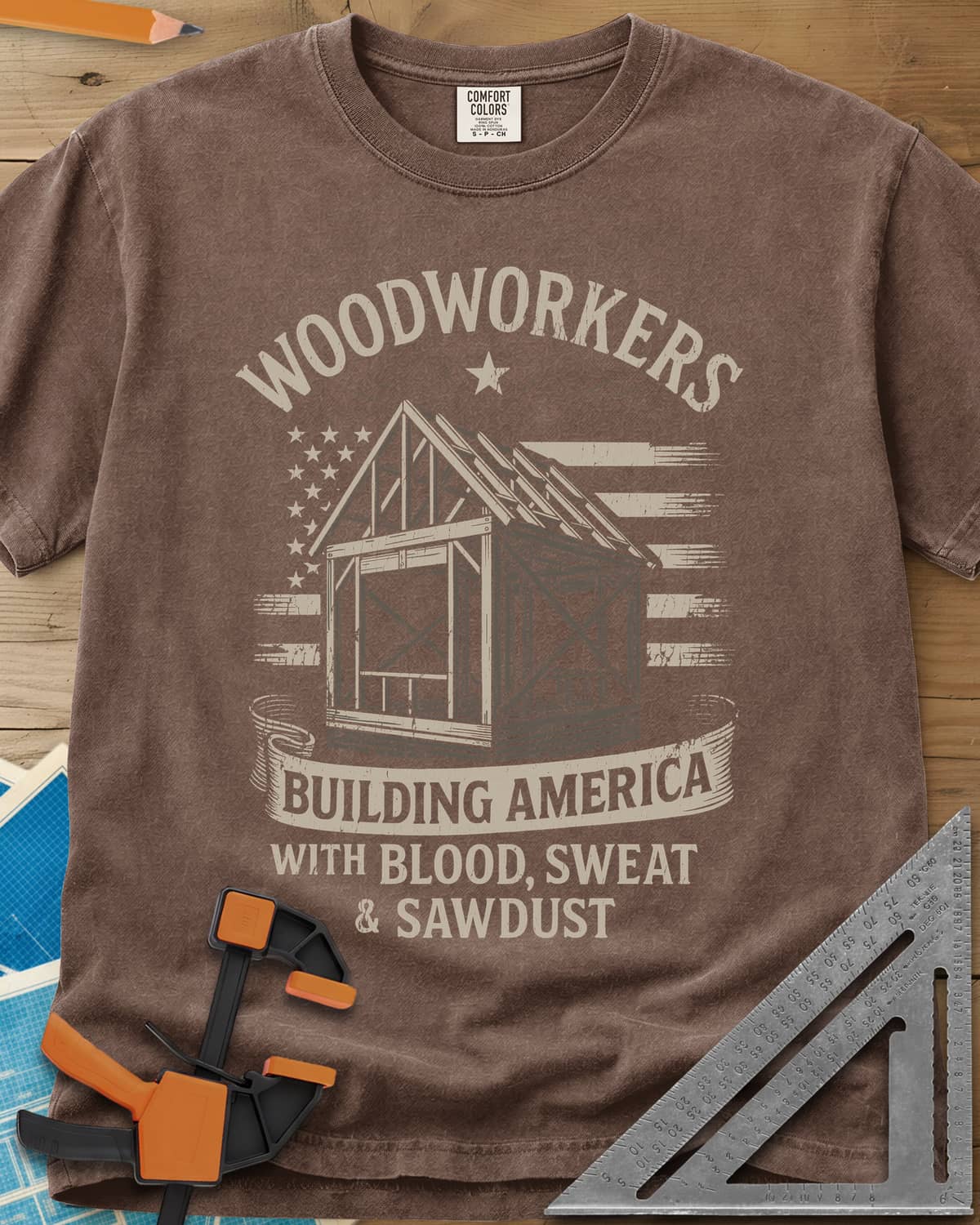 Building America heavyweight tee in Espresso, a timber frame in front of a worn American flag