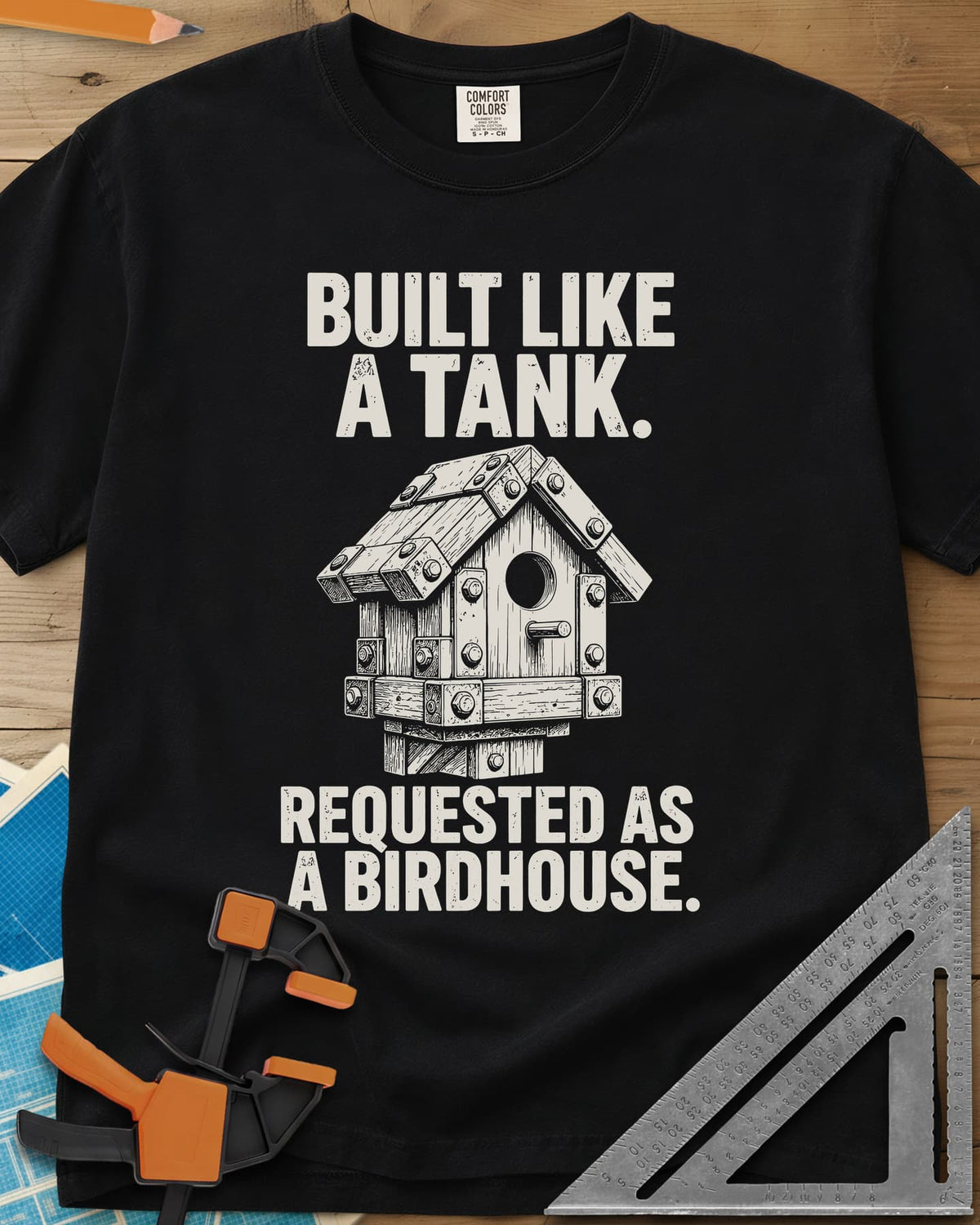 Built Like A Tank heavyweight tee in Black, a birdhouse armored with bolted plates and brackets