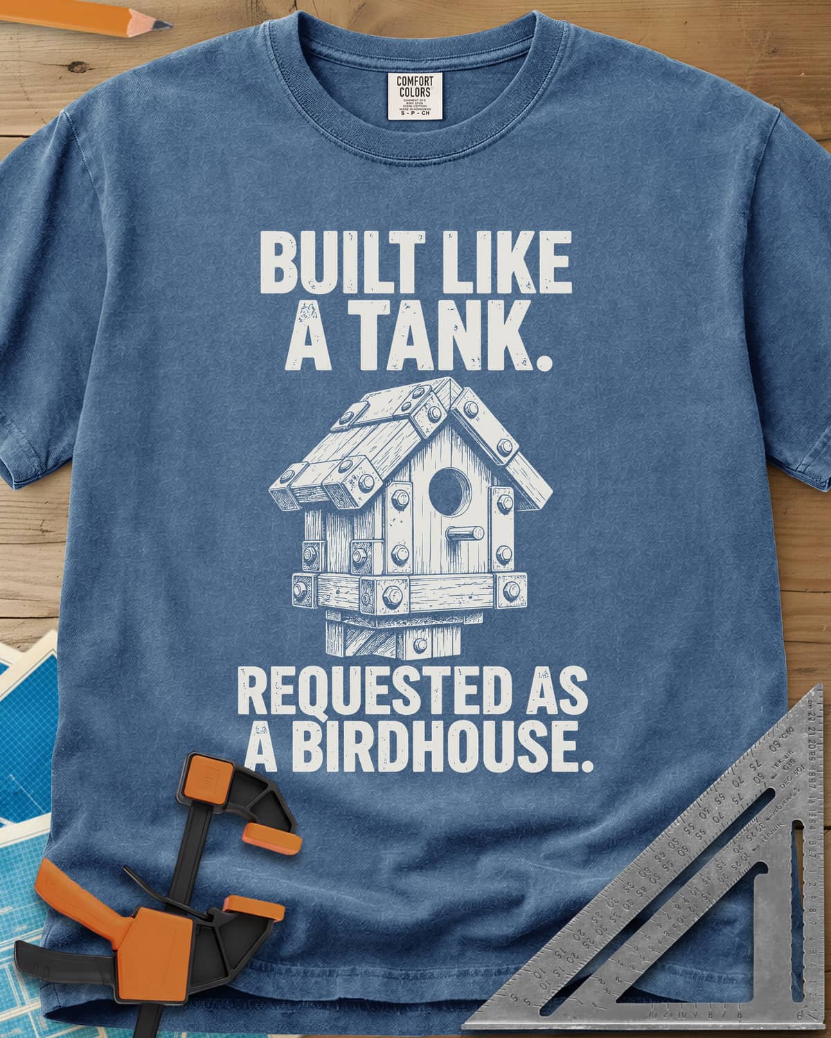 Built Like A Tank heavyweight tee in Blue Jean, a birdhouse armored with bolted plates and brackets