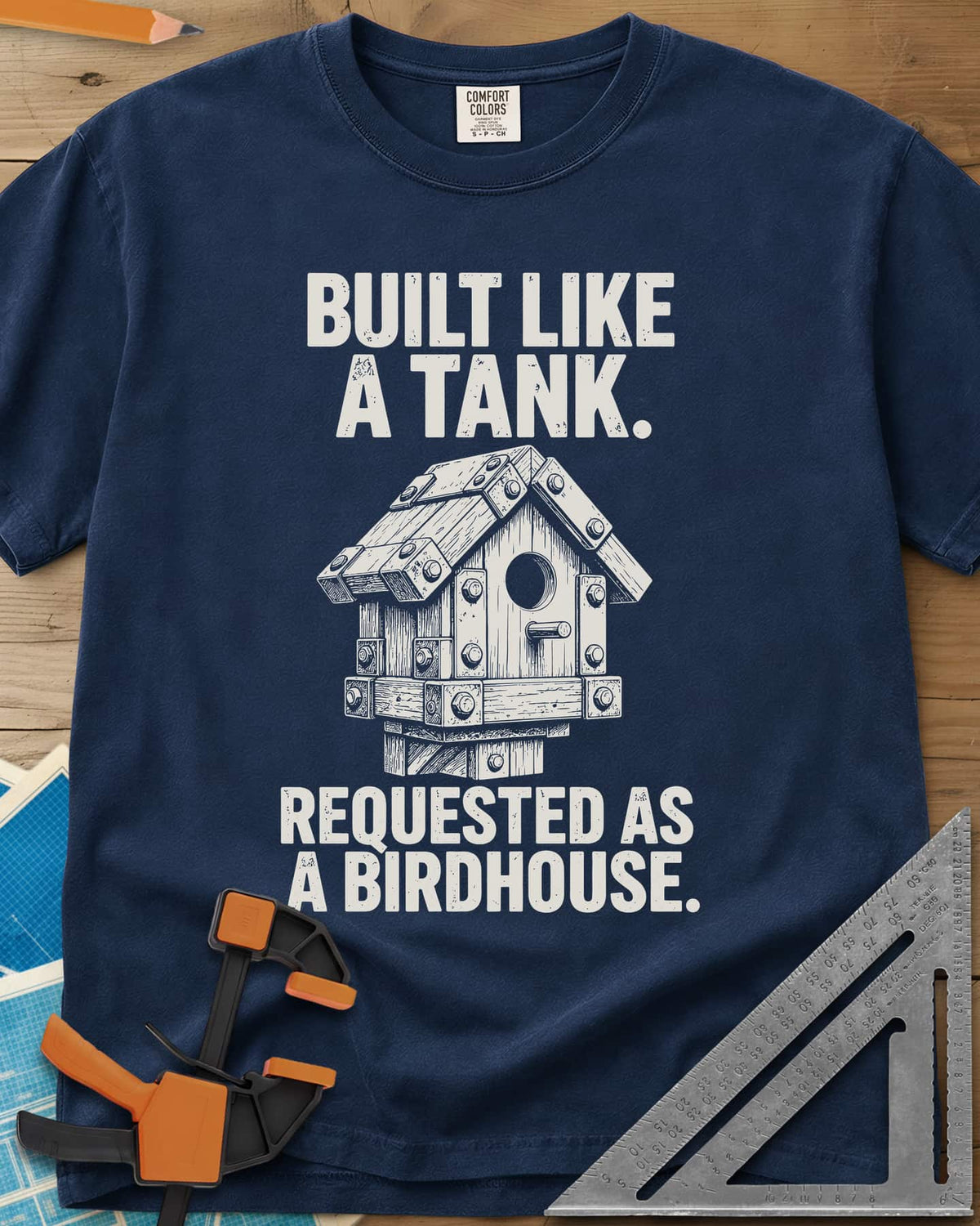 Built Like A Tank heavyweight tee in Navy, a birdhouse armored with bolted plates and brackets