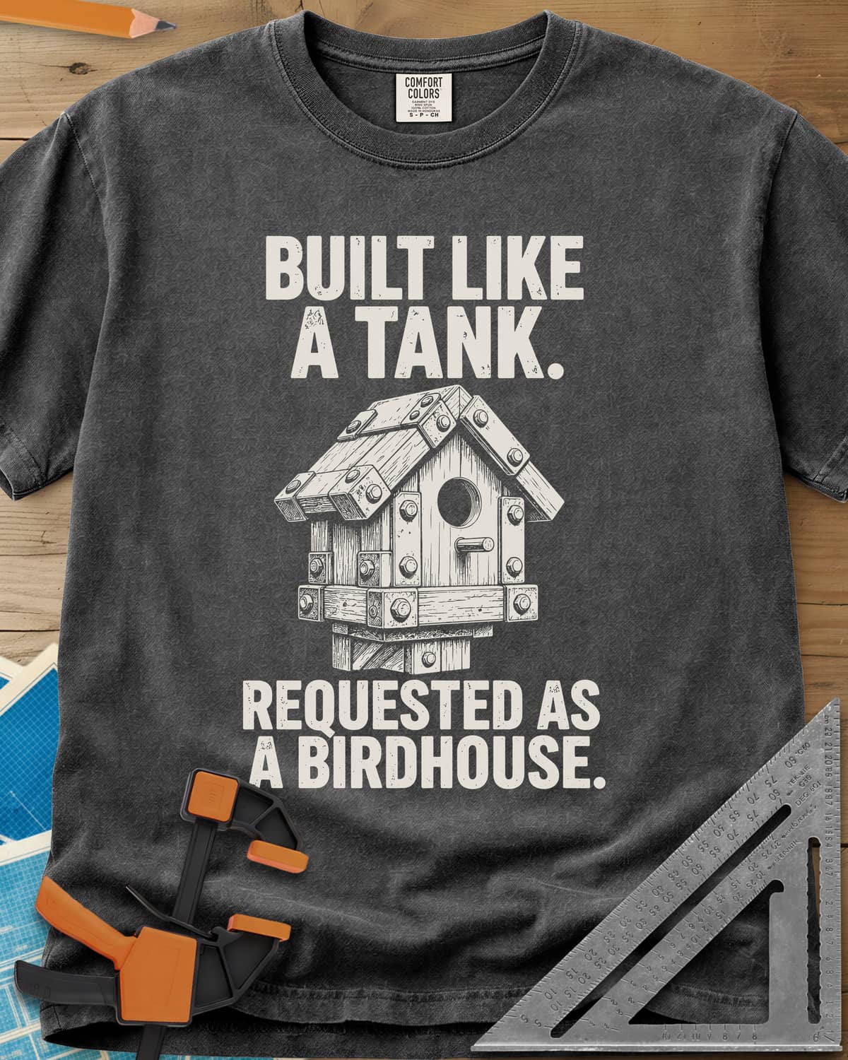 Built Like A Tank heavyweight tee in Pepper, a birdhouse armored with bolted plates and brackets