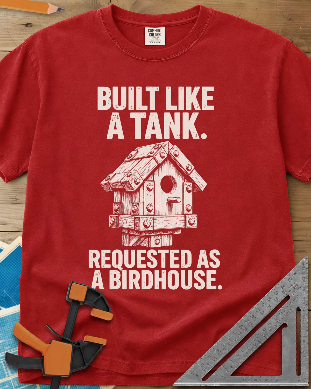 Built Like A Tank heavyweight tee in Red, a birdhouse armored with bolted plates and brackets