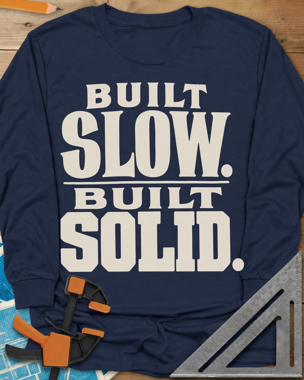 Built Solid long sleeve shirt in Navy, bold stacked wood-type lettering, no graphic