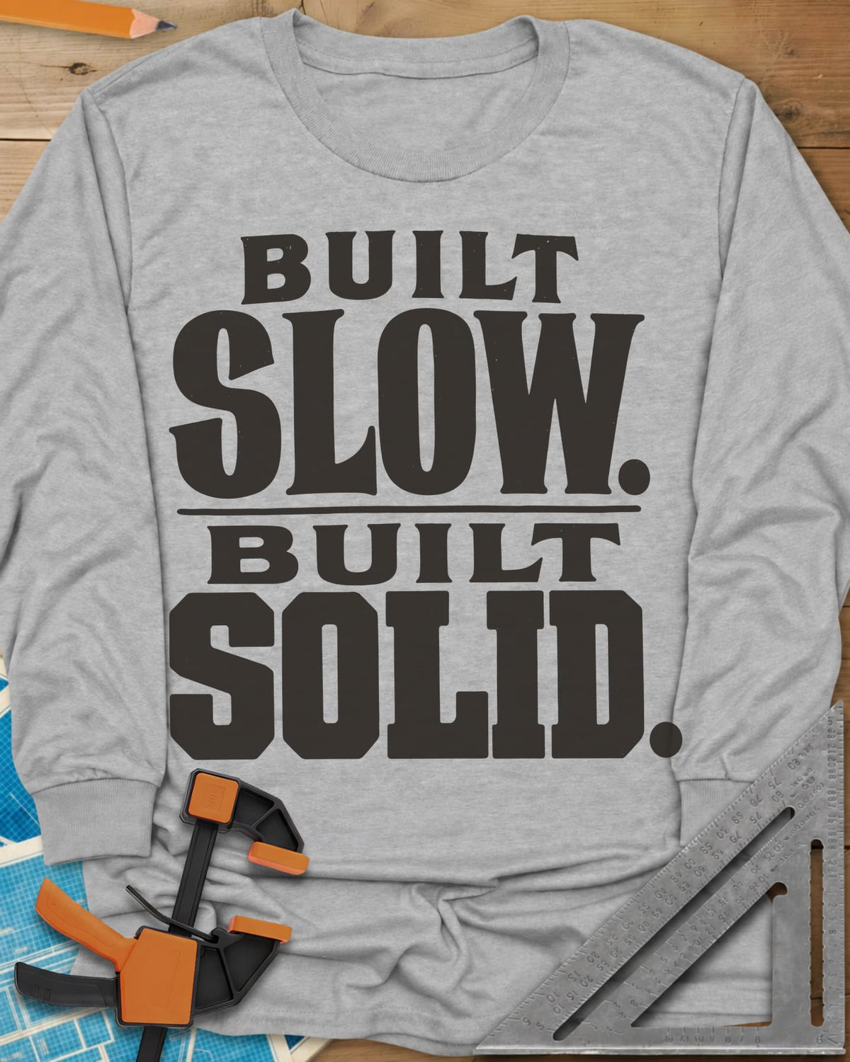 Built Solid long sleeve shirt in Sport Grey, bold stacked wood-type lettering, no graphic