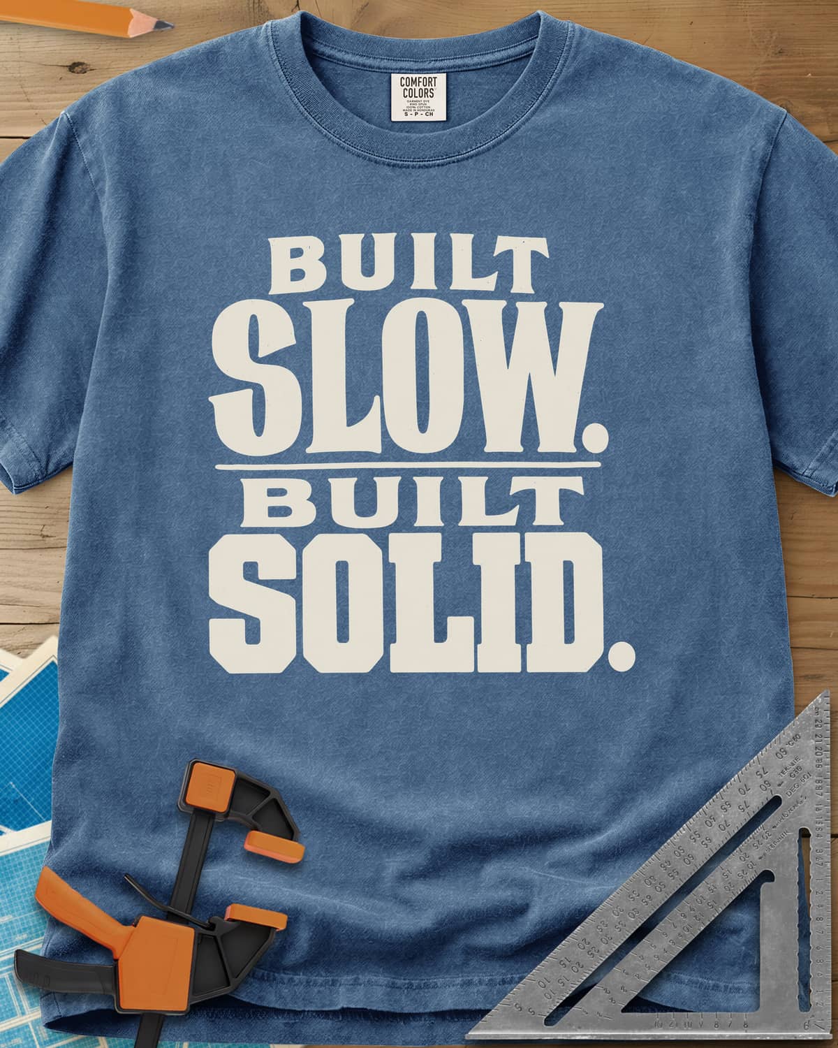 Built Solid heavyweight tee in Blue Jean, bold stacked wood-type lettering, no graphic