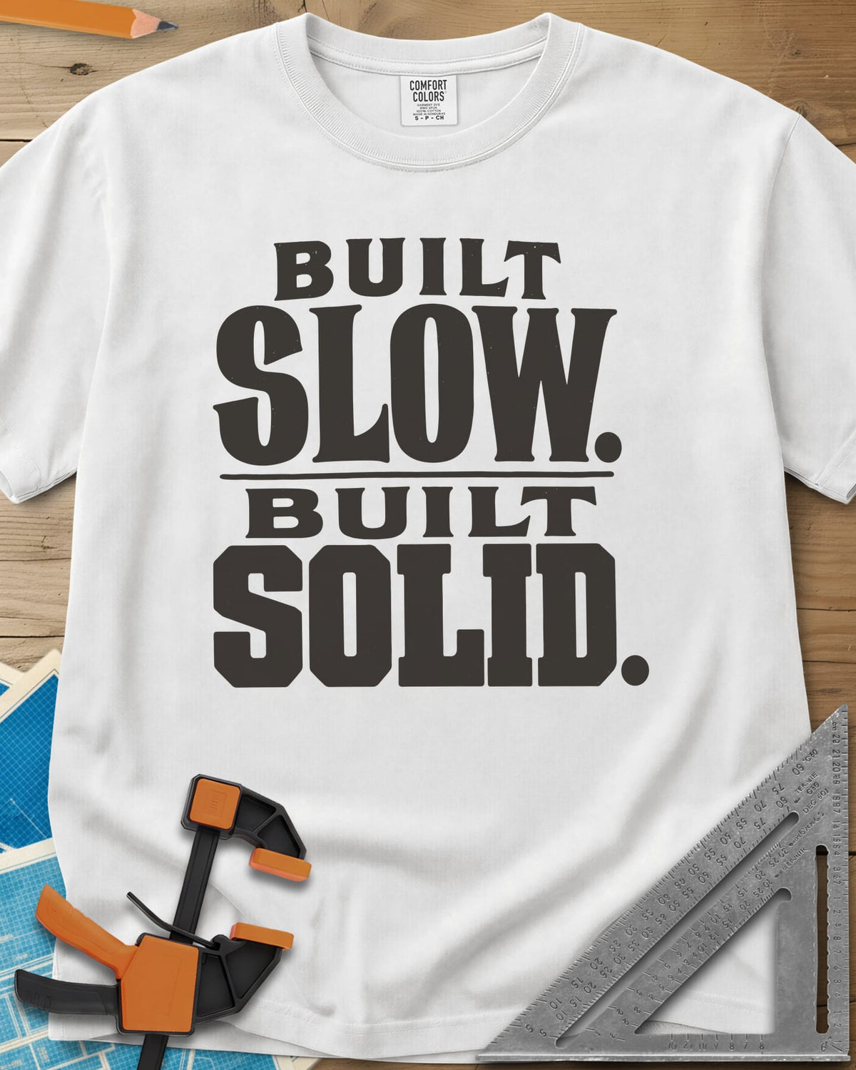Built Solid heavyweight tee in White, bold stacked wood-type lettering, no graphic