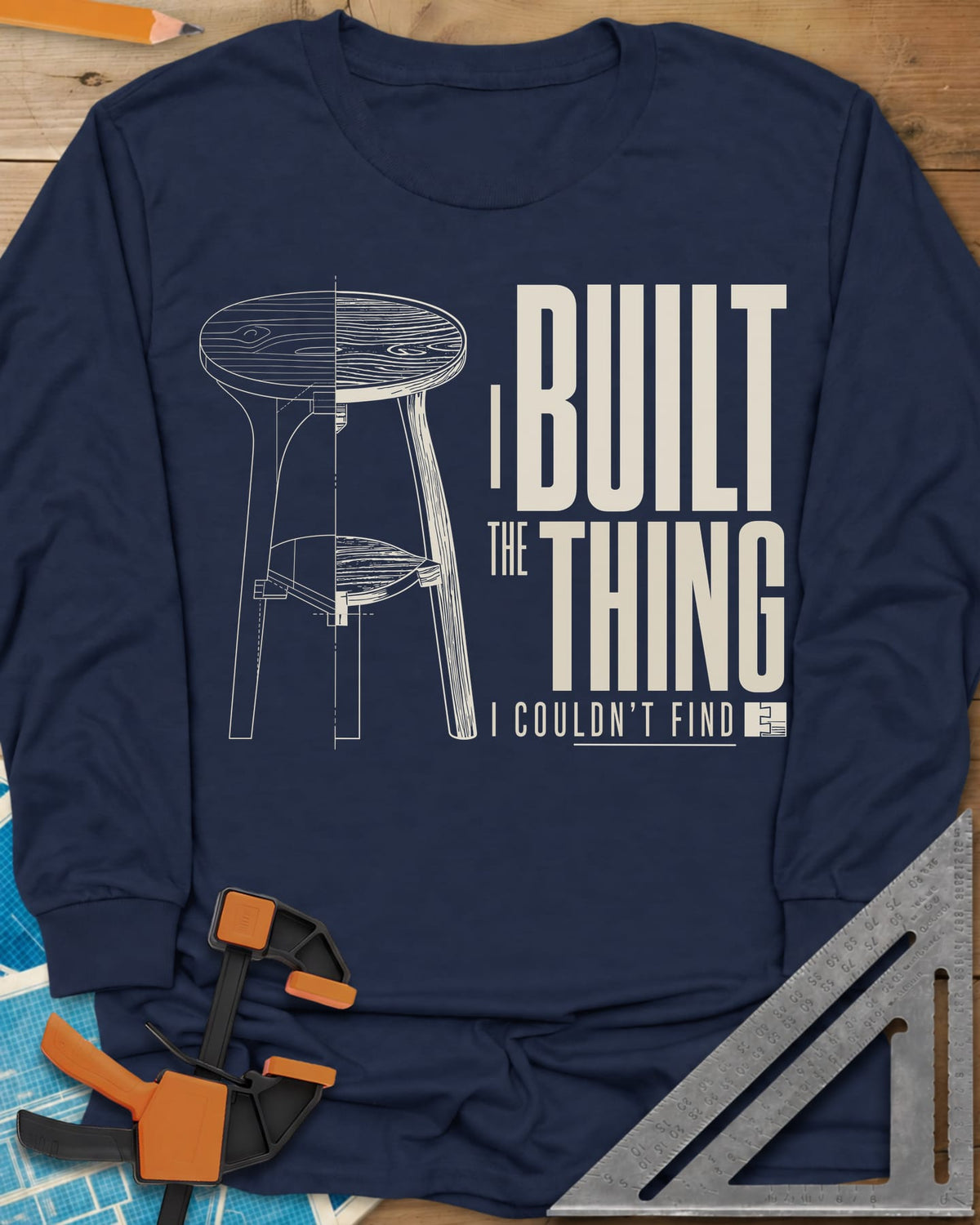 Built The Thing long sleeve shirt in Navy, a three-legged stool drawn half blueprint, half wood grain