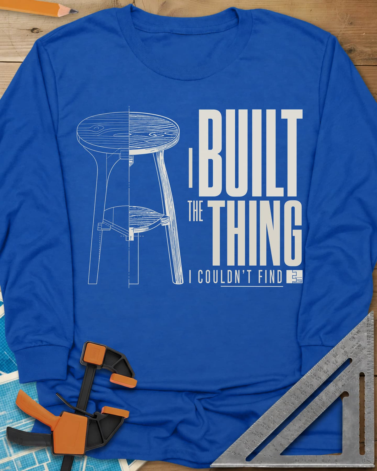 Built The Thing long sleeve shirt in Royal, a three-legged stool drawn half blueprint, half wood grain