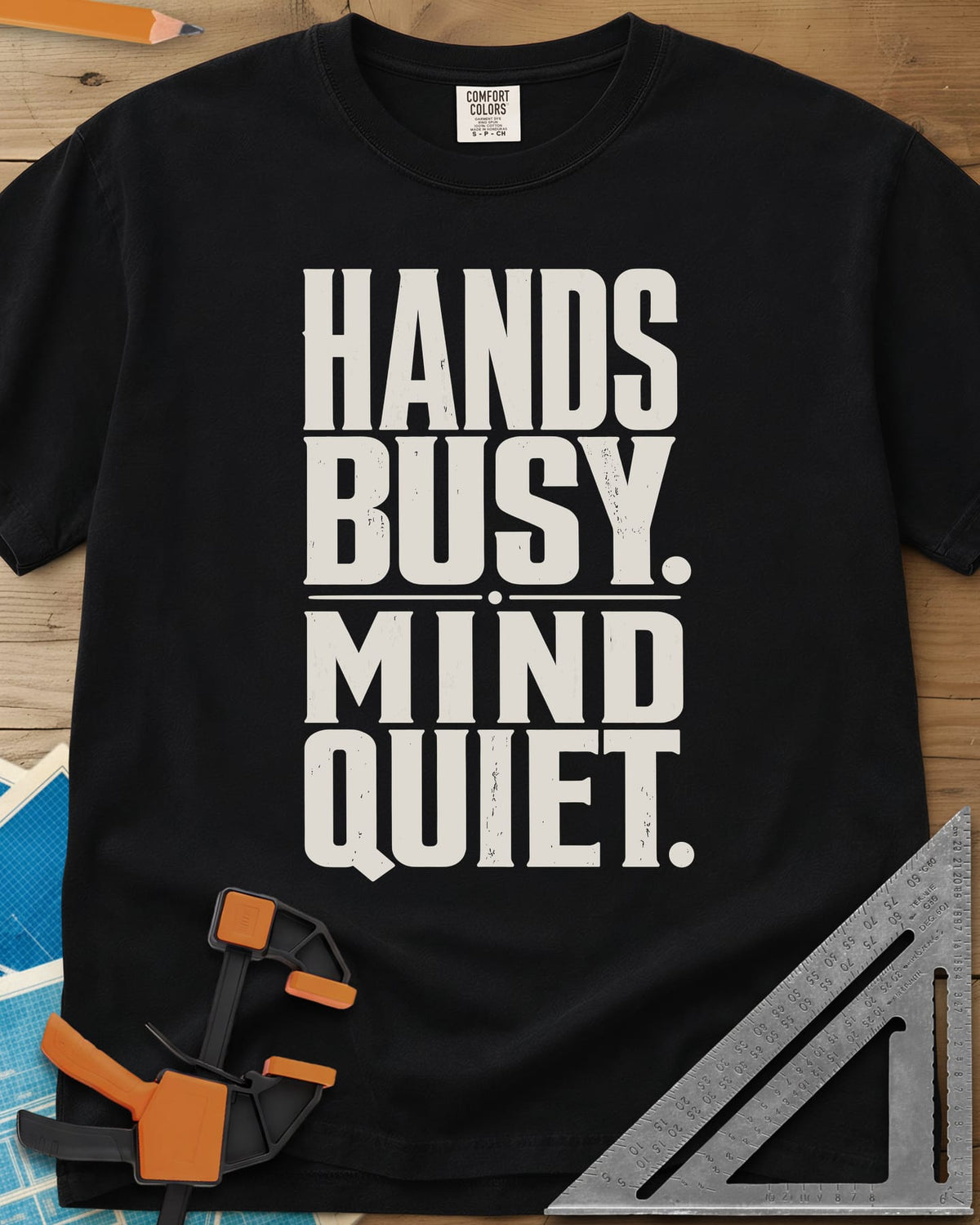 Busy Hands heavyweight tee in Black, tall stacked block capitals with a dotted divider, no graphic