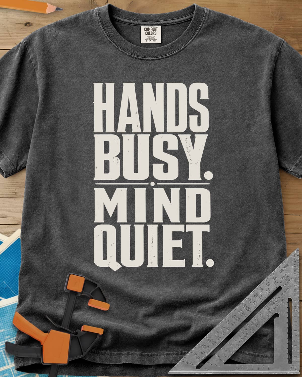 Busy Hands heavyweight tee in Pepper, tall stacked block capitals with a dotted divider, no graphic
