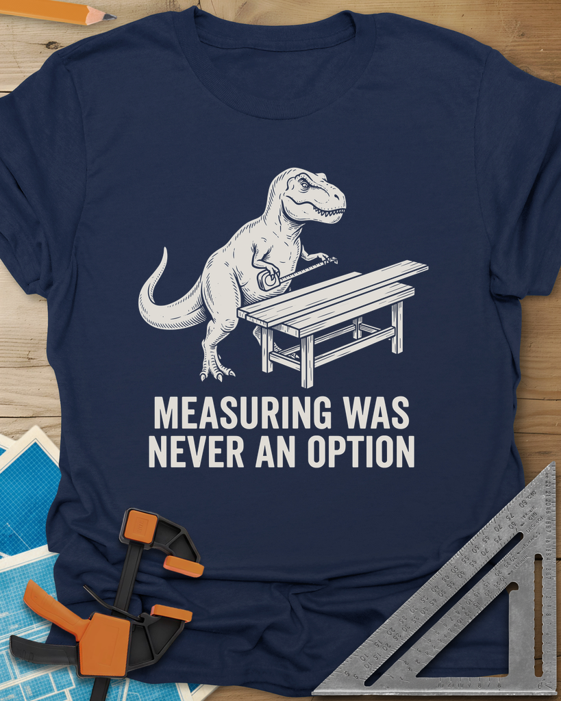 Dino Measuring t-shirt in Navy, a T. rex with a tape measure beside a plank workbench